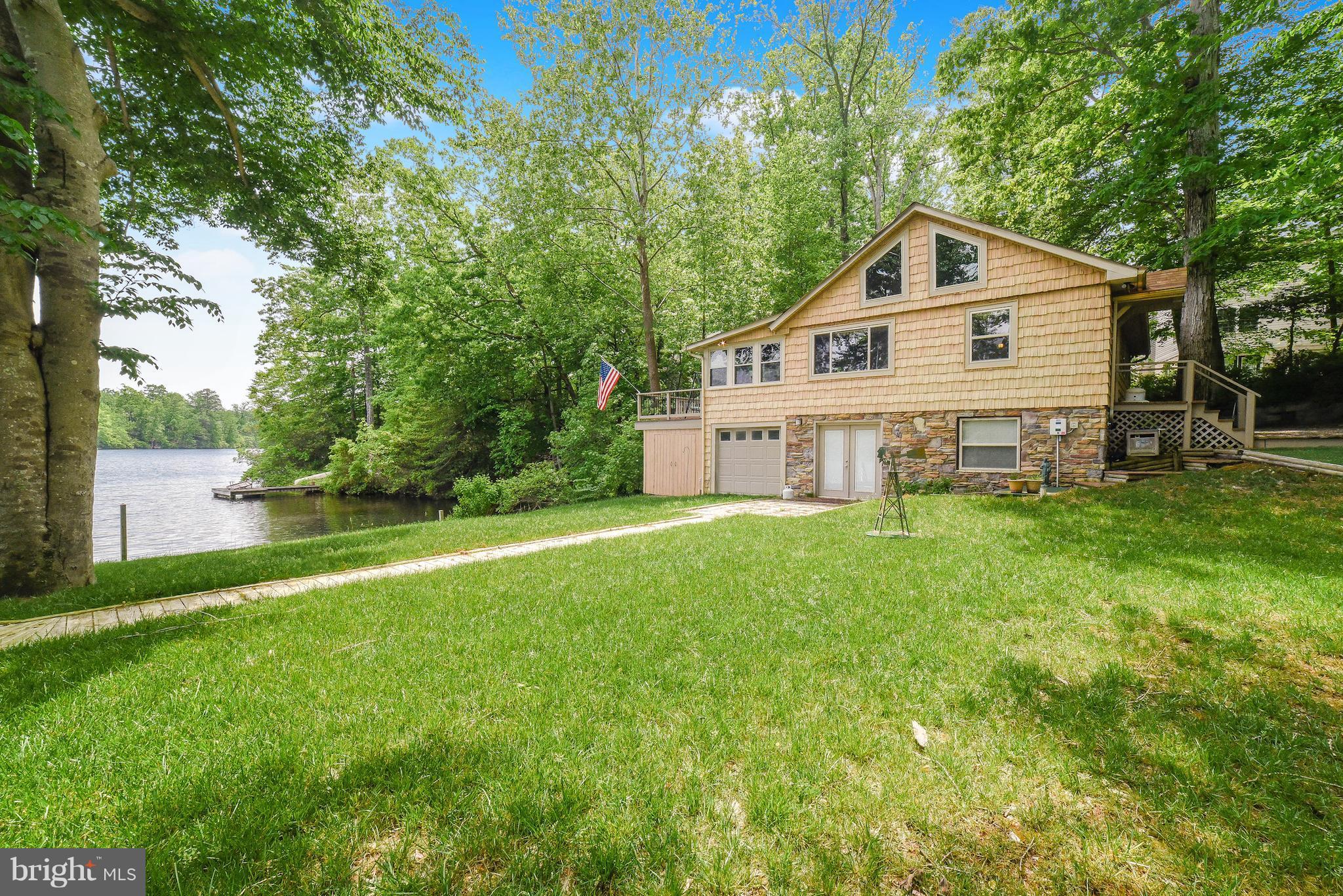 This Cabin is sure to recall summertime at the lake. This serene view is a beauty. The charm of the main floor cabin with terrific lake views is perfect for relaxing or entertaining friends. The newly finished basement area and bath with Steam Shower allow lots of space. The garage area will  provide excellent space for storage. Why reminisce of summers at the lake when you can live it.
