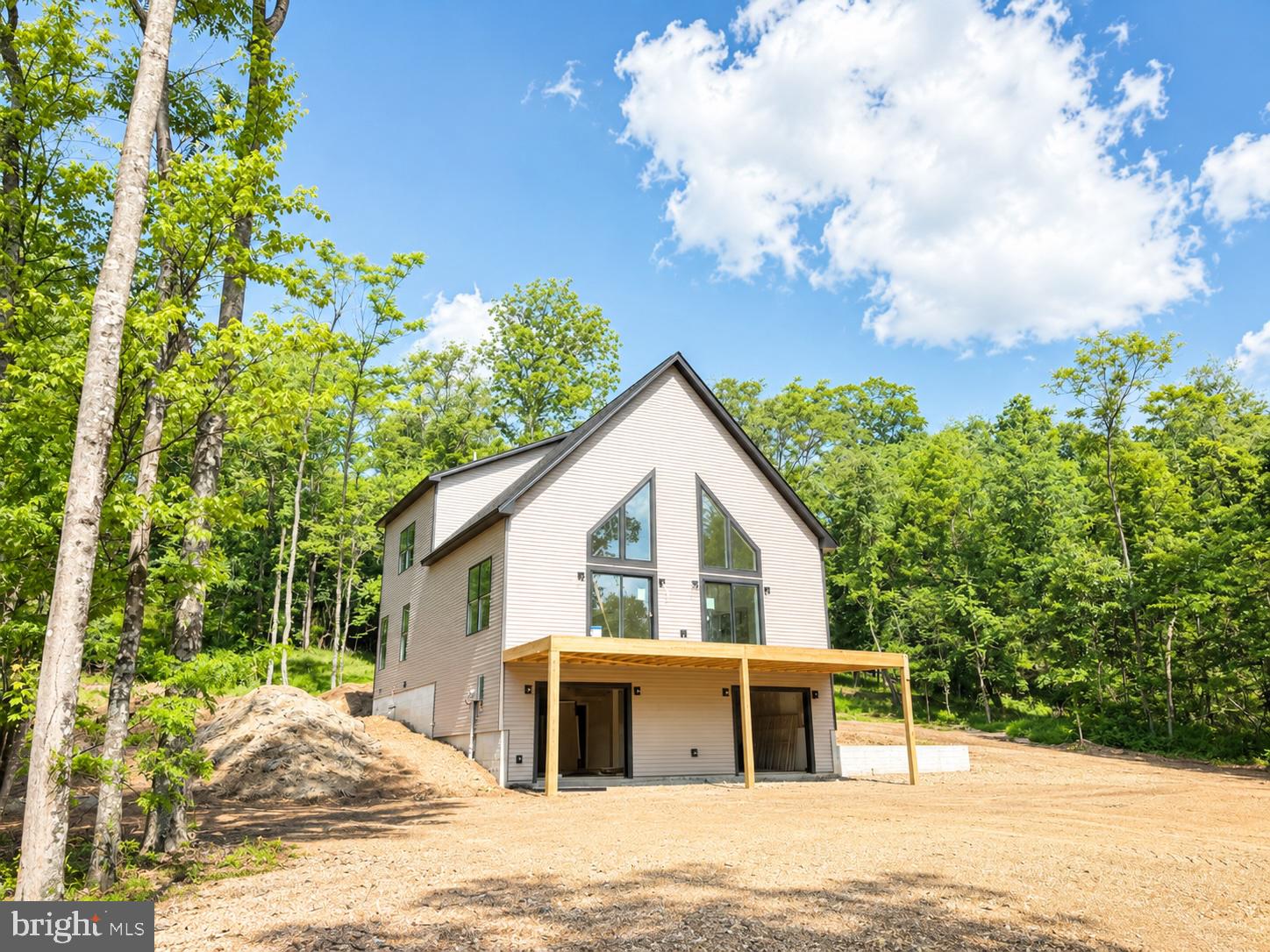 Discover the perfect blend of modern comfort and serene privacy in this beautifully crafted new construction chalet, nestled on 3+ wooded acres. This thoughtfully designed home offers a unique and functional layout ideal for both everyday living and weekend getaways.
The upper level features two spacious bedrooms and a full bathroom, providing a cozy retreat with peaceful wooded views. On the main level, you’ll find the primary bedroom along with private bathroom, and a half bathrooms, offering convenience and flexibility for guests or single-level living.
The heart of the home is the stunning kitchen, complete with a full 4-piece stainless steel appliance package, sleek granite countertops, and ample cabinetry—perfect for entertaining or preparing everyday meals.
The basement includes an additional half bathroom and finished rec room that offers great potential for future finishing or extra storage space.
Surrounded by nature, this property provides the privacy and tranquility you’ve been looking for while still offering the benefits of brand-new construction.
Don’t miss your opportunity to own this beautiful chalet retreat!   Photos are of similar construction and show some upgrades that are not included in the price.