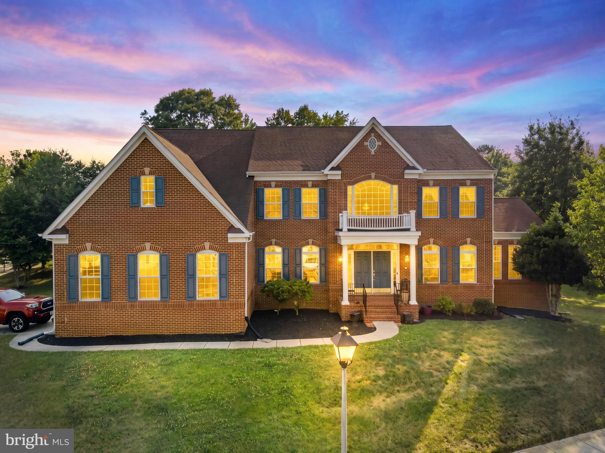 Welcome to this stunning **Monticello model** by Caruso Homes, an elegant estate residence that combines timeless design, luxurious finishes, and exceptional living spaces. Featuring a stately all-brick front and a grand two-story foyer, this home makes an unforgettable first impression.

The heart of the home is the expansive gourmet kitchen, complete with Corian countertops, stainless steel appliances, abundant cabinetry, a walk-in pantry, and a bright morning room—the perfect place to begin each day. Just steps away, the sunken family room showcases a cozy gas fireplace, creating an inviting space for gathering and relaxation. The main level also features a private home office, two convenient half baths, a formal living room, and a spacious sunroom. Step outside to enjoy not one, but two luxurious decks, offering the ideal setting for outdoor entertaining or peaceful evenings at home.

Upstairs, the grand primary suite is a true retreat, featuring a generous sitting area with a gas fireplace, an extraordinary walk-in closet, and a spa-inspired ensuite bath. The luxurious bathroom includes a soaking tub and an impressive double-sided walk-in shower, creating a private sanctuary you'll look forward to every day. Three additional spacious bedrooms, two full bathrooms, and a convenient upper-level laundry room complete the bedroom level.

The fully finished lower level is designed for entertaining on any scale. A large wet bar with generous seating anchors the space, complemented by a full bathroom and expansive recreation area with plenty of room for billiards, media, fitness, or game nights. Ample unfinished storage space also offers the potential to create additional bedrooms or customize the area to suit your needs.

Perfectly situated for commuters, this exceptional home offers convenient access to Washington, D.C., Northern Virginia, Route 5, and Route 210, providing an ideal balance of luxury living and everyday convenience.