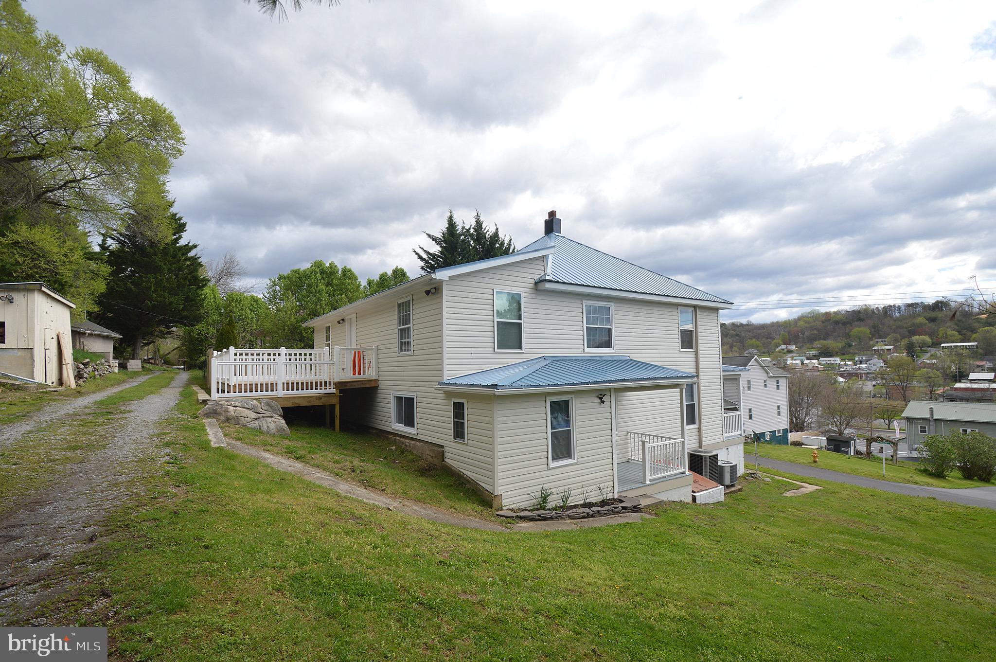 Charming home in historic Berkeley Springs.   Current owner took the home down to studs and remodeled every bit of the home.  Main level bedroom with a full bath and half bath.  Upstairs has 4 bedrooms with 2 full baths. Large kitchen, full dining room, and large living room are nice features.  Outside features a walk in deck into the upper level of home.  It also features a fenced yard, shed, and parking area out back accessed by an alley way. Newer roof, siding, flooring, appliances, and much more to make this a very nice home to live in and has quick and easy access to many road ways.  Street was recently paved last year as well. A must see!
