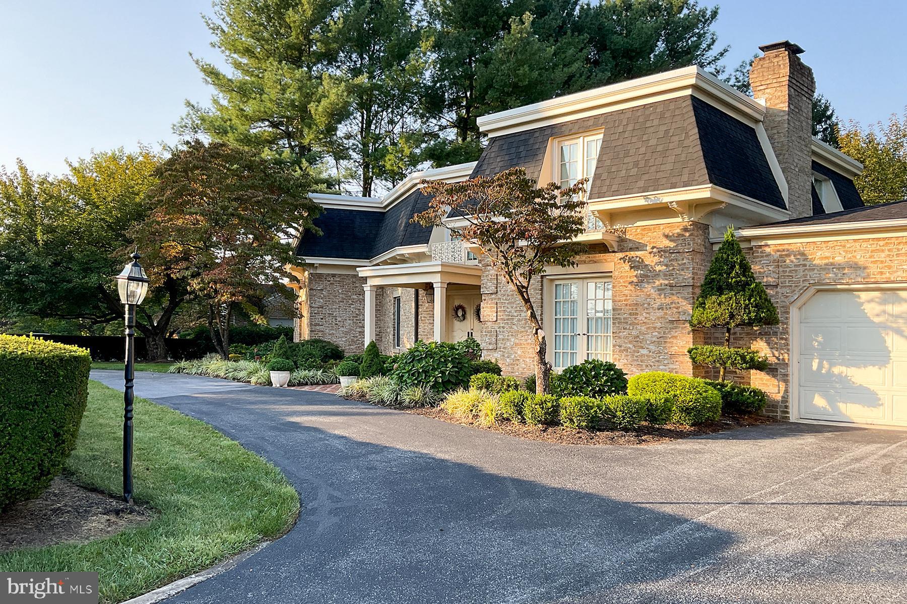 Stunning French Colonial in sought after Spring Valley!  Truly a must see.   4,990 +/- sq ft! Step into this elegant home through a grand marble foyer with a sweeping staircase that sets the tone for luxury living. The spacious floor plan features a stately living room accented with classic pillars, and a formal dining room complete with custom built-in china cabinets and a charming window seat. The gourmet kitchen is a chef’s dream, boasting stainless steel appliances, a large granite island, custom cabinetry, pantry, and a gas stove. A sun-filled sunroom, with oversized windows and French doors, opens to a vast brick patio perfect for outdoor entertaining. Ride the two-person elevator to the luxurious primary suite, featuring two large closets and a private dressing room. The upper level also includes three additional generously sized bedrooms and three full baths. On the main level, enjoy the cozy family room with custom cabinetry and a grand fireplace, along with the convenience of a first-floor laundry room, storage, and a second half bath. The oversized two-car garage offers plenty of space for vehicles and more. The finished lower level is designed for entertainment and relaxation, with a spacious game room complete with a fireplace and bar, an exercise room, cedar closet, wine room with custom storage, and plenty of extra storage with built-in shelving. This meticulously maintained one-owner home feels like a model and is move-in ready! Economical gas heat! Large spacious foyer with marble floor. Motivated seller!