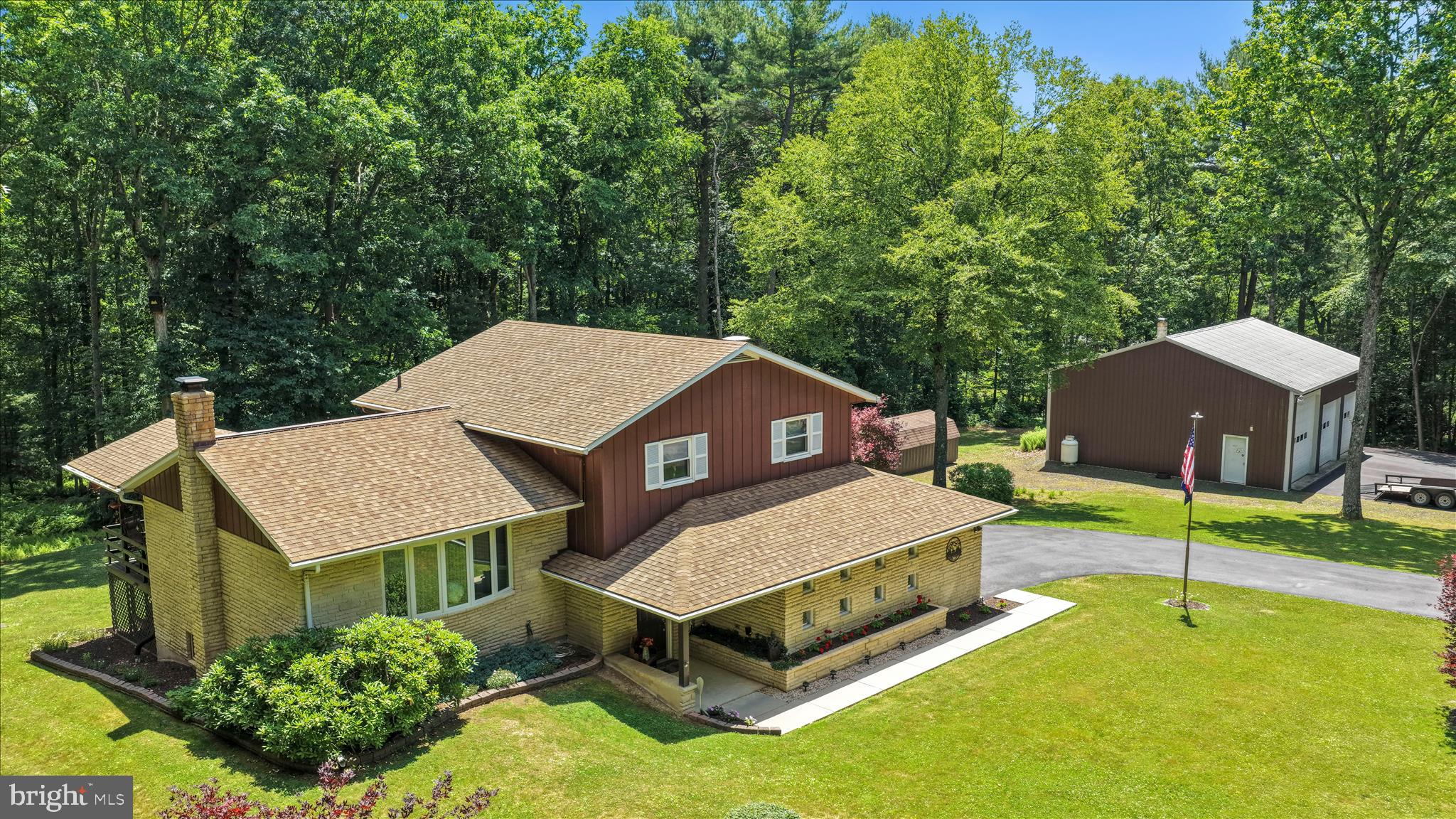 Welcome to this immaculately maintained split-level home nestled on 2.4 beautiful acres in Pine Grove. Proudly built and lovingly cared for by its original owner, this 3-bedroom, 1.5-bath home showcases quality, comfort, and pride of ownership throughout. The spacious bedrooms offer generous closet space, including a primary suite with double closets. The full bath features a beautifully tiled floor and walk-in shower, while the open-concept kitchen is highlighted by a stunning wood beam, center island, stainless steel appliances, and easy access to the deck overlooking the backyard.

The lower level offers a cozy family room with a gas fireplace, laundry area, and convenient powder room. Additional features include updated windows, central air, central vacuum, generator readiness, and a basement workshop with a coal stove for supplemental heat. The attached two-car garage provides everyday convenience, while the newer roof with Roof Maxx treatment, seamless gutters, blacktop driveway, beautiful landscaping, and stunning Japanese maple trees add to the home’s exceptional curb appeal.

Outdoor enthusiasts will appreciate the impressive 40’ x 36’ heated detached garage featuring three overhead doors, a camper-height bay, floor drain, camper hookups, and attic storage. Previously used for deer processing, this versatile space is ideal for hunters, hobbyists, contractors, or anyone needing extra room. A 12’ x 20’ storage shed provides additional space for lawn and garden equipment.

The property offers a wonderful blend of open and wooded land, with level yard space for entertaining, recreation, and gatherings. Mature ferns blanket the wooded section, where a walking path invites peaceful evening strolls. Located in a quiet country setting just minutes from Pine Grove and local interstates, this exceptional property offers the perfect balance of privacy, convenience, and outdoor enjoyment. Schedule your private showing today!