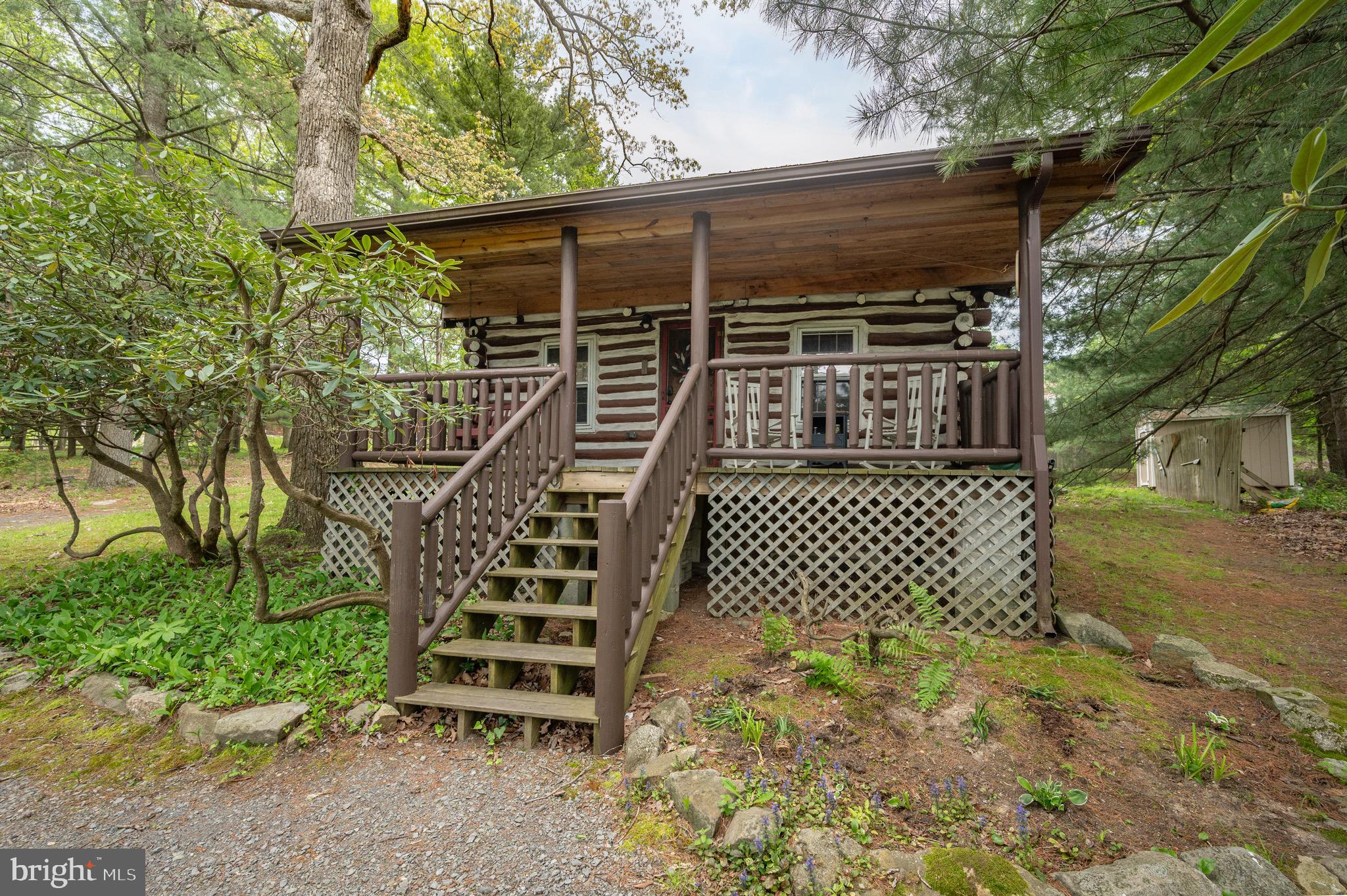 Charming vintage Deep Creek Lake log cabin ideally located in the heart of Deep Creek Lake just minutes from area amenities. Full of character and thoughtfully restored, this established rental property is being sold completely furnished and turnkey. Enjoy filtered lake views from the inviting covered front porch, then unwind in the hot tub or gather around the fire pit after a day on the lake. Conveniently located directly across from Silver Tree Marine and Dutch’s at Silver Tree and just a short drive to Deep Creek Lake State Park. A rare opportunity to own a truly unique Deep Creek getaway with timeless cabin charm!