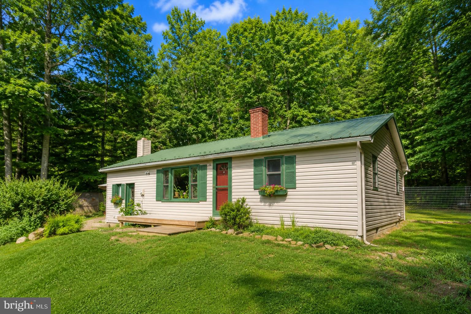 Tucked away in a peaceful, nature-filled setting, this charming 2-bedroom, 1-bath ranch offers comfortable one-level living with a truly unique atmosphere. Surrounded by colorful wildflowers and mature landscaping, the property provides a quiet retreat that's perfect for enjoying the outdoors. Inside, the home has seen several recent upgrades, making it move-in ready while maintaining its inviting character. A detached one-car garage provides additional storage, and the greenhouse is a standout feature for gardening enthusiasts, hobbyists, or anyone looking to grow their own plants and produce. Conveniently located just outside downtown Oakland, you'll enjoy easy access to local shops, restaurants, schools, parks, and all the year-round recreation Garrett County has to offer.