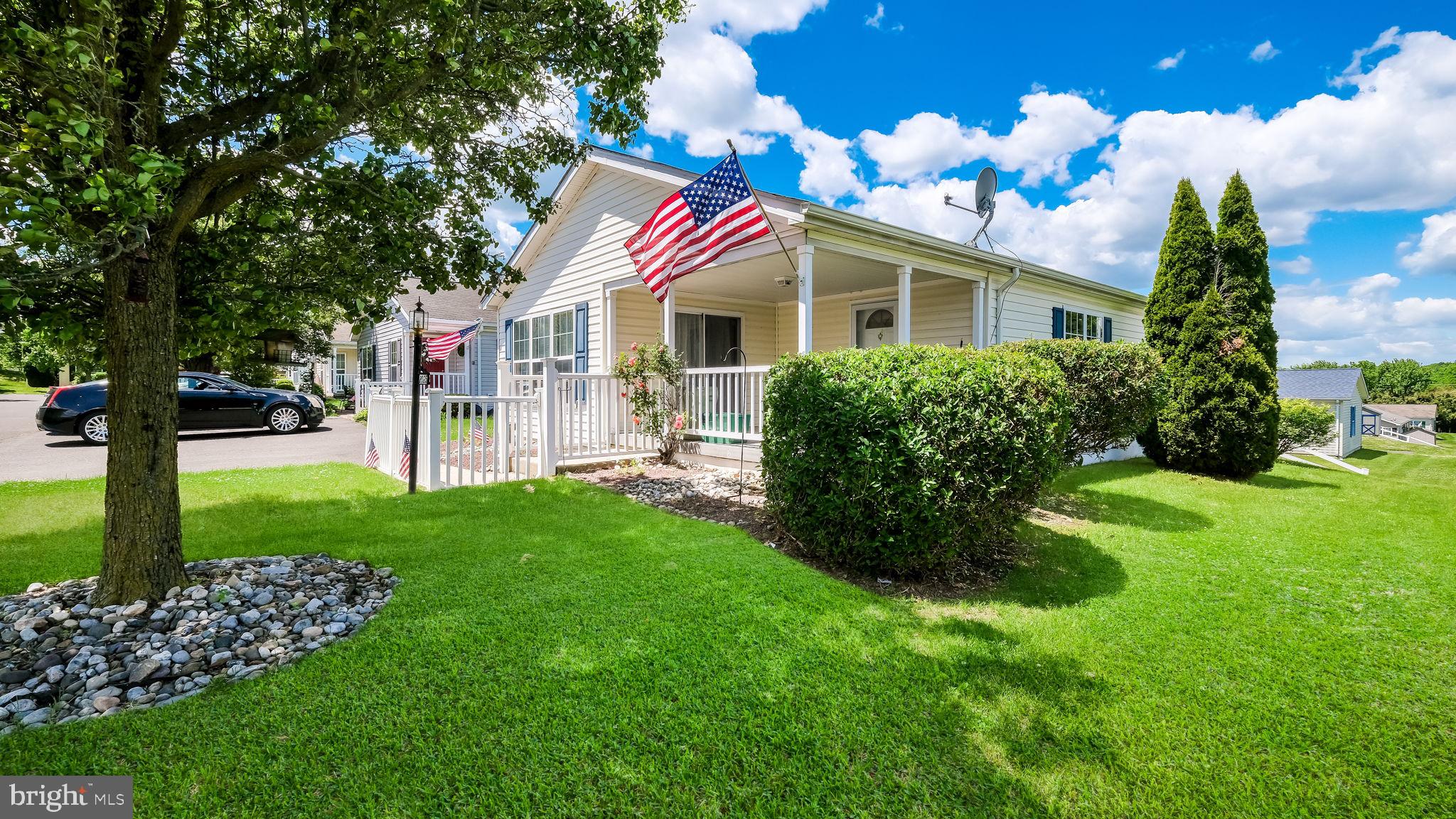 Welcome to the Village of Neshaminy Falls!  Wonderful curb appeal with manicured gardens and fencing. This well maintained 2003 home offers over 1,350 square feet of comfortable living space with 2 bedrooms and 2 full bathrooms.  Great open layout featuring a spacious living room and dining room open to the kitchen with extended countertops.   Enjoy relaxing on the front porch or in the bright sunroom/den featuring a slider leading to a porch. Conveniently located within walking distance to the new clubhouse and community pool. Additional features include a shed for extra storage. Major updates include a roof installed in June 2021, carpeting installed in June 2022 (excluding bedrooms), and a new a/c-heat pump unit installed in August 2025, The monthly ground rent includes clubhouse, pool, community room and sewer. The community room is beautiful and features a library, fitness room, game room and so much more. Many activities/clubs offered along with weekly shuttle to area markets, Fabulous community and a wonderful place to call home!