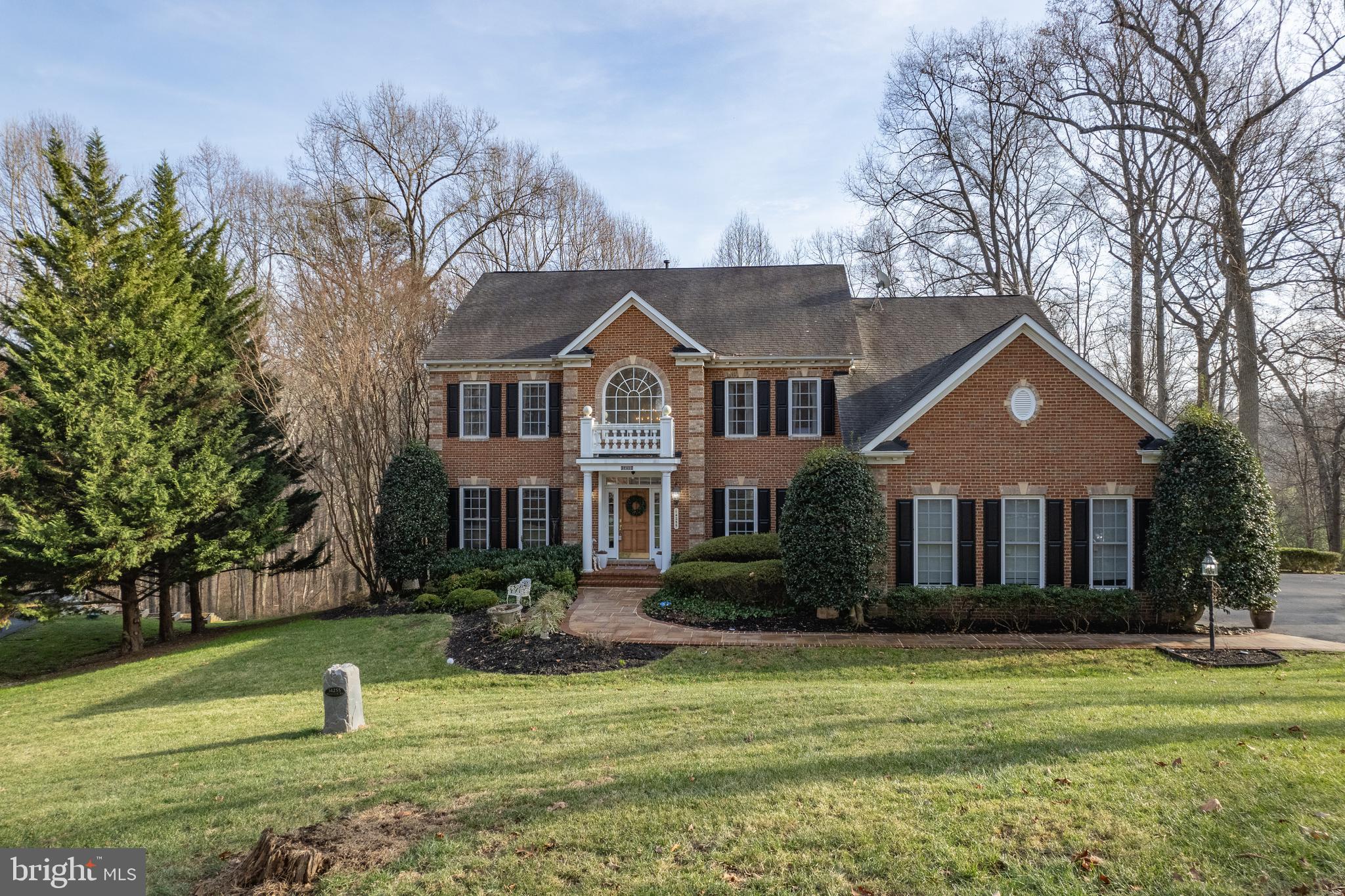Gorgeous brick NV Hyde Park residence with over 6,000 square feet of luxurious living. Located off Linthicum Road and accessed by beautiful country roads, this small community gives you the perfect balance of a neighborhood and a remote setting. Nestled on over an acre, this home’s mature landscaping provides privacy and tranquility. The interior features six bedrooms, four and a half ceramic bathrooms, nine-foot ceilings and hardwood flooring. With plenty of space for entertaining, the main level floor plan is perfect for gatherings and offers all the amenities for convenient daily living, including a mudroom, a laundry room, a private office, and a secondary staircase leading upstairs. The gourmet chef's kitchen boasts antiqued granite countertops, forty-two-inch maple cabinets, stainless steel appliances, a gas cooktop, double ovens, a large island, a breakfast bar, and a bright window lit sitting area providing direct access to the maintenance free deck and screened gazebo. Surrounding the gorgeous kitchen is a large formal dining room and a family room with cathedral ceilings, a gas fireplace, and solarium adorned in windows. Retreat to the upper-level primary suite with a tray ceiling, ceiling fan, custom closet organizers in the walk-in closet and two other closets, and a large updated bathroom with granite countertops, double sink, soaking tub, and sit-in shower. Complementing the primary suite upstairs is a large dressing room (4th BR) equipped with custom closet organizers, along with two additional bedrooms, each with their own private ensuite bathrooms. The walk-out lower level provides even more living space with nine-foot ceilings and plenty of windows to bring in the natural light, and it is the perfect area to escape or entertain. There is a bar area, billiard room, two additional bedrooms, a full bathroom and a media room equipped with surround sound, full screen and projector. The lower level could easily serve as an in-law, au pair or rental suite. Walk-out to the slate and paved partially covered rear patio with a four-person hot tub overlooking the serene back yard with lovely views and a charming shed. Other fine details of this home include dual zone HVAC units, gas heat, gas hot water heater, water softener system, architectural shingle roof and a three-car side-load garage.
