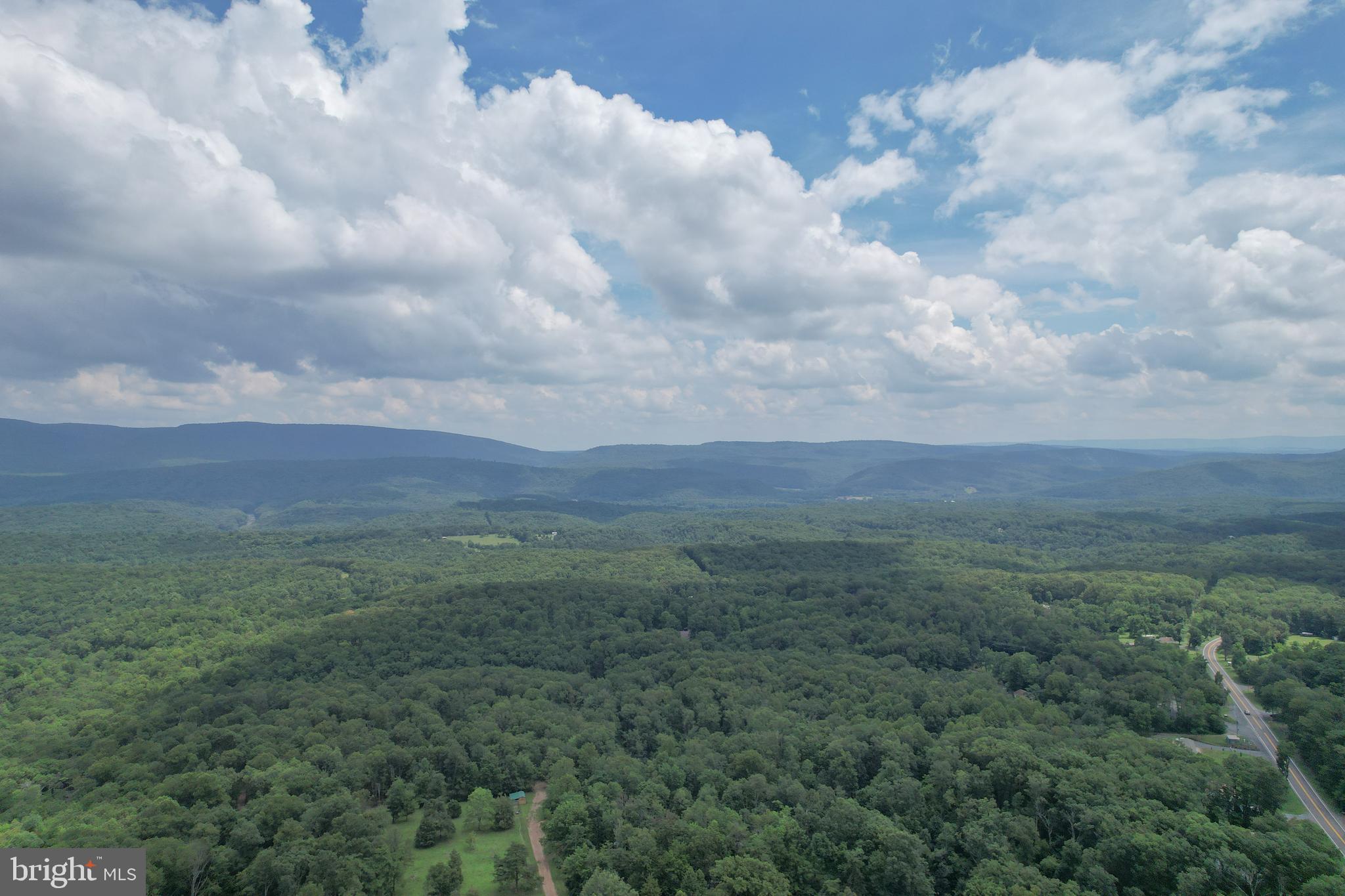 Ready to build your dream mountain home?  This 5 acres corner lot is an divine opportunity to set up your mountain escape.  Located within the rural Cacapon Heights neighborhood where privacy is paramount, this lovely parcel will make a gorgeous home site.   The property is raw land and has not been improved or percolated for well or septic.   Neighboring homes have been built in recent years as this mountain development continues to expand.  A road maintenance agreement is in place for snow removal on the neighborhood roads which are mainly gravel and moderately passable at times.  Make an investment in land in Hampshire County, West Virginia where wild meets wonderful!  You can drive to the land, there are signs on the property.  Property starts at the corner of Eastland Drive and Mountain Top Road and has road frontage on both sides.  Driveway access was initially developed on Eastland Drive and is still somewhat accessible.  Park at gates out of the roadway to walk/ access property.  Do not trespass on other property.