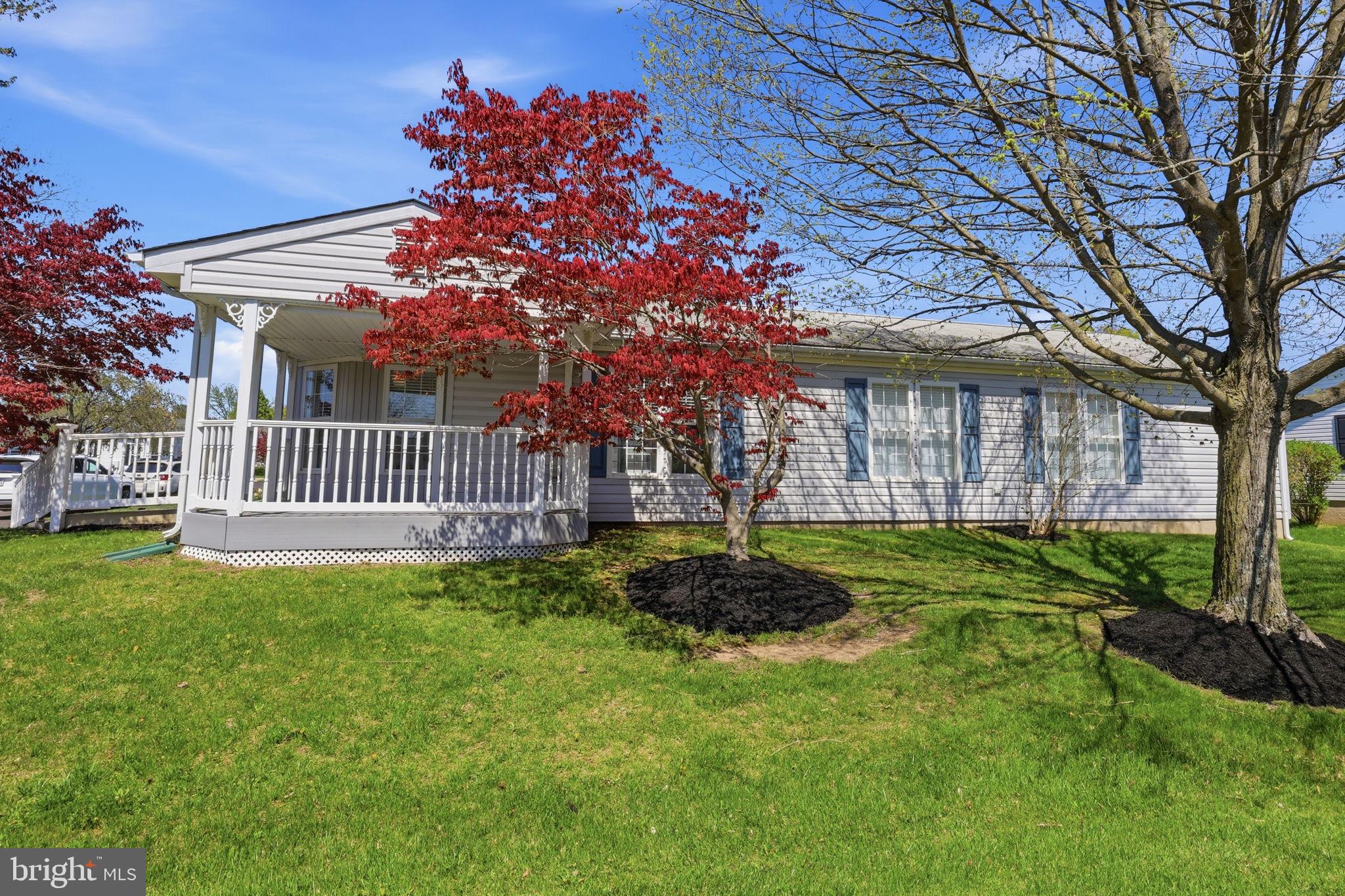 Welcome to the vibrant 55+ adult community of Buckingham Springs! 119 E Goldenrod Crossing is a charming 3-bedroom, 2 full bath move-in ready ranch home that offers excellent curb appeal. The sprawling, manicured lawn and an expansive covered front porch, provides a perfect shaded retreat for outdoor relaxation. A welcoming foyer with durable transition flooring leads into an open-concept interior designed for modern living. Brand new plush carpeting and neutral decor throughout. Large double windows create a bright, airy atmosphere throughout this versatile central living space. Anchored by a classic chandelier and ceiling medallion, the dedicated dining space flows seamlessly into the main living quarters. As showcased in the staged photos, the room comfortably accommodates a full-sized table for formal hosting or daily meals. The well-appointed kitchen features extensive oak cabinetry paired with beautiful granite counter space for easy meal preparation. Laminated wood flooring and a clean white appliance suite complete this functional workspace, which remains open to the home's social areas. The primary bedroom offers a spacious retreat with neutral tones and a large window that fills the room with natural light. It also features an ensuite bathroom complete with dual sinks, combination tub and shower and a convenient linen closet. Two additional bedrooms offer plush carpeting and ample closet space for organization. The hall full bathroom is beautifully maintained, showcasing an oak vanity topped with granite, generous storage space, a skylight that fills the room with natural light, and pristine fixtures. The functional laundry room, complete with abundant storage, also serves as a mudroom and opens to a rear deck—perfect for easy indoor-outdoor living and entertaining.  The property also includes a large shed for additional storage and a two-car driveway. This inviting home is in move-in-ready condition, offering a clean slate for the next owner’s personal style. Located minutes from New Hope and Doylestown, the Buckingham Springs Community offers relaxed, active living. Enjoy a clubhouse with outdoor heated swimming pool and spa, private bus service for scheduled outings, on-site management, and fun activities. Don't wait and come see how you can make this house your new HOME!