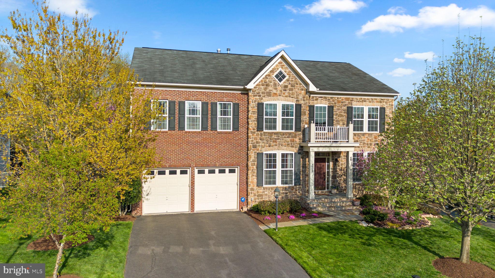 Welcome to 9323 Castle Hill Road, a stunning stone and brick residence in Springfield’s sought-after Belmead neighborhood, perfectly positioned within the Sangster/Lake Braddock school pyramid and just steps from scenic trails, commuter options, and everyday conveniences.

This meticulously maintained home makes a striking first impression with its stately brick and stone façade, professional landscaping, and vibrant flowering trees. Inside, a soaring two-story foyer welcomes you with gleaming hardwood floors, elegant wainscoting, chair rail and crown molding, and sun-filled formal living spaces designed for both everyday comfort and sophisticated entertaining. A bright home office with glass French doors provides a quiet retreat for today’s professional.

The gourmet kitchen features a center island, pendant lighting, sunroom bump-out for casual dining, and seamless flow to the formal dining room with a bay window overlooking the neighborhood pond and fountain. The inviting family room with gas fireplace opens directly to a custom wraparound slate patio with built-in Bull grill and outdoor cooking station, creating the perfect setting for entertaining or relaxing in the beautifully landscaped, private backyard.

Upstairs, the expansive primary suite offers a sitting area with a second gas fireplace, double tray ceiling, two walk-in closets, and a luxurious bath with soaking tub and separate shower. Three additional bedrooms include an ensuite, a Jack-and-Jill bath, and a versatile loft space, along with the convenience of an upper-level laundry room.

The finished lower level is built for entertainment, featuring brand-new flooring, a spacious recreation room, wet bar with beverage fridge, and a soundproof home theater with Sony projector, BMW speakers, and a 110" 4K screen, plus two flexible bonus rooms and a full bath.

Outdoor enthusiasts will love the nearby trails to Burke Lake, Mercer Lake, and South Run Rec Center, while commuters enjoy a bus stop less than a block away, Gambrill Road Park & Ride just minutes away, and a short drive to Franconia-Springfield Metro, I-95, and Fairfax County Parkway. Huntsman Square shopping and dining are also just moments from home.

Recent updates include a new two-zone HVAC system (2025), new sump pump (2025), newer hot water heater (2019), EV-wired garage, and sprinkler system.

Offering approximately 5,800 square feet of beautifully designed living space, this exceptional home blends timeless elegance, modern convenience, and an unbeatable Springfield lifestyle.