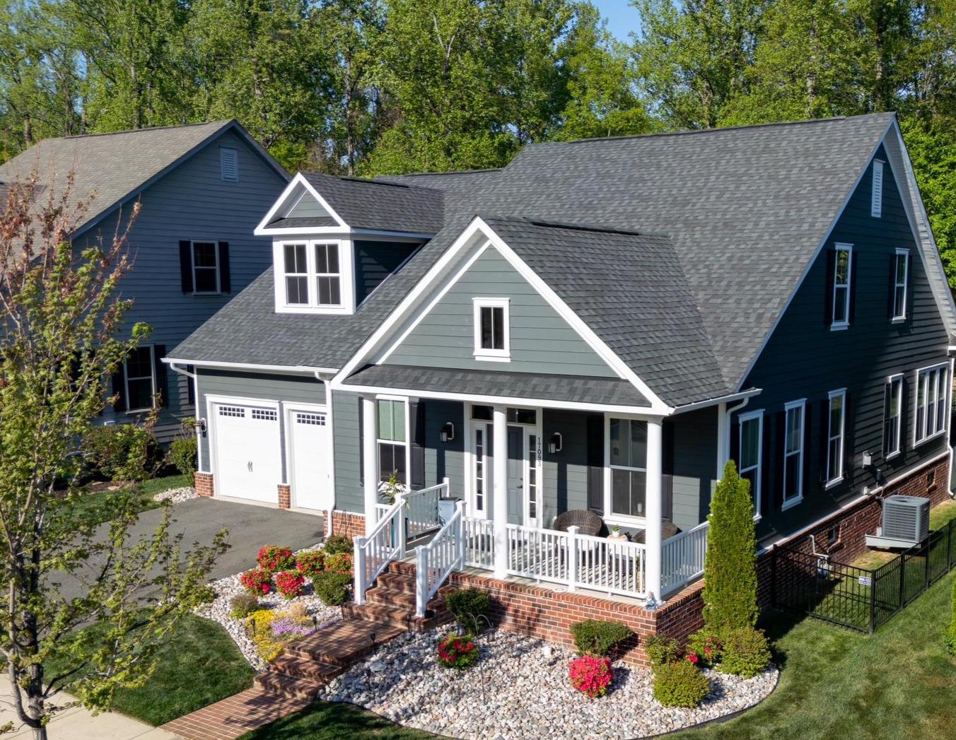 Imagine this craftsman-styled home, complete with a loft and a finished basement, perfectly sited on a premium lot, backing to lush trees. Experience this popular, waterfront community offering the Potomac Shores Lifestyle--Destination for a LIFETIME.  The Jack Nicklaus Signature Golf Course, Clubhouse, and welcoming Tidewater Grill set the scene.  The neighborhood offers a network of scenic hiking trails, the unparalleled 13,000 sf Shores Club complex featuring a state-of-the-art fitness center, pools, a demonstration kitchen, social barn, and community gardens. The elementary and middle schools are located within the neighborhood.  The future community town center and the VRE-Virginia Railway Express commuter rail station will bring everything you need to one location. This location has convenient commuter access to Ft. Belvoir, Quantico Marine Base and Washington, D.C.  The incredible community sets the stage for this unique property offering.  Step inside and discover fabulous main-level living with dramatic 18-foot ceilings in the grand room, built-in bookcases that frame the cozy gas fireplace, hardwood flooring, and the designer features that you've grown accustomed to.  The gourmet kitchen features a gathering island and custom cabinetry with decorative glass fronts.  Venture out to the Trex-style composite deck and custom patio overlooking the fenced backyard. The lawn Irrigation system is in place and helps keep the landscape beautiful. The primary suite with an EnSuite luxury bathroom is on the back of the house for scenic views and quiet privacy.  Step upstairs to the bright, spacious loft area, where a separate space awaits your guests. Downstairs, the lower level is attractively finished with a large family room and private 4th bedroom suite.  Whether it's movie night or your relaxing yoga practice, you'll feel right at home in this space.  Abundant storage and a convenient walk-up to the backyard finish the area.  If you want the main level living without downsizing or age restrictions, Plan to Tour this bright, open. and well-appointed home in the Premier Potomac Shores neighborhood and make this your new Destination.