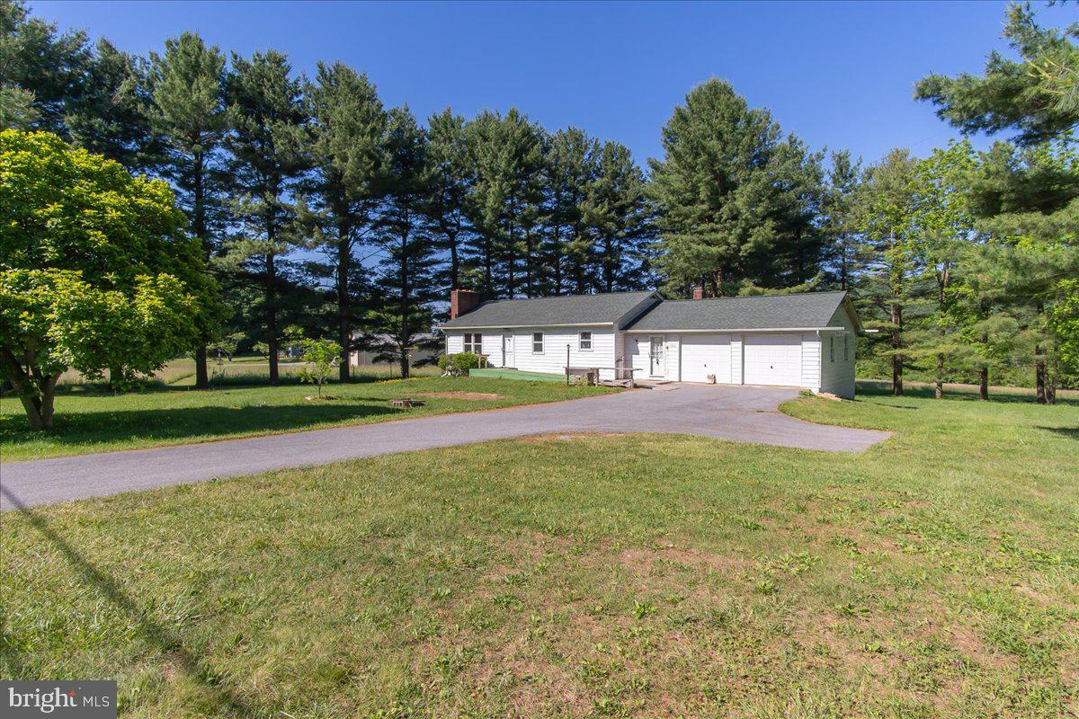 Welcome To Wolfsville!   Great Starter Home/Lots of potential or Handy-Man Special!  Hardwood Floors, double garage, a huge finished "breezeway" between the house and garage/with a fireplace, 2nd fireplace is in the Living Room.    Eat-in kitchen, living room, 2 bedrooms, 1 bath, and full unfinished basement to finish to your liking - with a walk-out/at grade level.   Almost 3 acres - amazing location/beautiful views, literally 5 minutes down the mountain to the shopping zones.     SOLD STRICTLY AS IS TO SETTLE ESTATE;  Highly doubtful will go USDA or FHA due to chipping peeling paint on exterior.