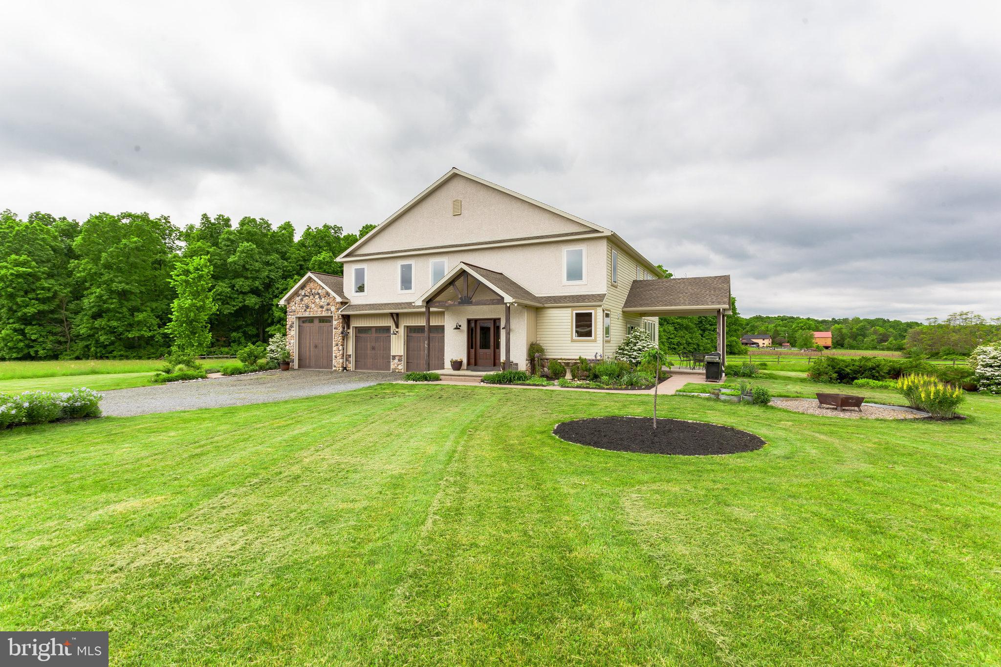 Breathe in serenity and breathe out the stress of your home search, the modern farmhouse of your dreams has just made its debut on the market. Make your way down the tree lined driveway and you'll arrive at this stately compound featuring a 3,800+ square foot, 3 car garage home and a 40x50 barn on 10.25 acres that has been built to satisfy your every need. This palatial home has 6 bedrooms, 4 full baths, 2 half baths, an in-law suite and a finished basement. Step into your sun lit foyer and notice the beautifully crafted barn doors that flank your entry, each displaying a different path of travel. No expense was spared in making this kitchen feel like a chef's paradise! This kitchen features custom painted raised panel two tone cabinets, a huge island, designer backsplash, high end stainless steel appliances, recessed and under cabinet lighting and was deliberately poised to optimize the natural sunlight. There is an uninterrupted sight line into the 2 story open area family room with double sliders and oversized windows that invite the picturesque view of the outside, into your home to enjoy.  This level houses the in-law suite with its own dedicated patio entrance, a kitchenette, living space and an impressive en suite bath that is sure to wow even the most discerning mother in law. The first floor owner's suite is not to be outshined with a coffered ceiling, walk-in shower, walk-in closet and a bathroom that rivals your local 5 star hotel.  A half bath and mudroom round out this level. The second floor has an additional 4 bedrooms, all with oversized closets, a jack and jill bathroom, your ideal work from home office space and an easily accessible hallway bathroom. The lower level is your entertainment hotspot! This large secondary living space has a 324 bottle wine cellar, a wet bar, the same great booth seating you would find at your favorite restaurant, and enough space to store your comfy sectional and ping pong or pool table! All serviced by a half bath making this level self sufficient and ready for your next party! There is no shortage of storage as there has been preserved unfinished space for easy access to stored items.  This estate has a working barn that is currently catered to the breeding and care of livestock, but was built to be totally versatile. This structure has a 40x50 shelter area, 5 partially closed off 12' overhead garage doors, 2nd floor access to a hay loft with elevator and drop, 4 horse stalls, a tack room, washroom, a variety of outdoor runs and turnouts, a riding rink and 4 paddocks. This home's unique versatility makes it a sure stand out in today's market and is ready to help its new owner enjoy the rustic farm life without having to sacrifice any modern amenities!