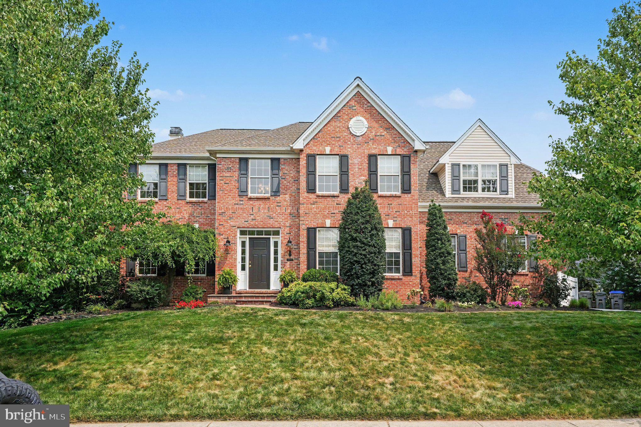 Welcome to this exceptional 4-bedroom, 2.5-bath brick-front Colonial, perfectly situated in the highly desirable Walnut Grove community and the award-winning Spring-Ford School District. Thoughtfully updated and impeccably maintained, this home offers the perfect blend of timeless elegance, modern amenities, and inviting living spaces.
Beautiful hardwood flooring extends throughout the main level, where you'll find a stunning gourmet kitchen designed for both everyday living and entertaining. The kitchen features upgraded white cabinetry, granite countertops, a tile backsplash, stainless steel appliances, recessed and pendant lighting, a coffee and wine bar, and an oversized center island with seating for six. Sliding glass doors lead directly to the spacious rear deck, creating a seamless indoor-outdoor living experience.
Open to the kitchen, the dramatic two-story family room is filled with natural light from its impressive floor-to-ceiling windows and is anchored by a beautiful brick wood-burning fireplace, creating the perfect gathering space for family and friends.
The formal dining room showcases elegant wood trim, wainscoting, and chair rail molding and is currently being enjoyed as a formal living room. A private first-floor office with upgraded flooring and custom French doors provides an ideal work-from-home space. Completing the main level are a beautifully updated powder room and mudroom, both renovated in 2026.
Upstairs, the center hall staircase leads to three generously sized secondary bedrooms, a beautifully remodeled hall bathroom completed in 2024, and a spacious primary suite designed as a private retreat. The owner's suite features a tray ceiling, upgraded carpeting, a large walk-in closet with custom built-in shelving, and a luxurious en-suite bath with dual vanities, tile flooring, an oversized glass-enclosed tile shower, and a separate soaking tub.
The finished lower level offers outstanding flexibility with a spacious recreation room, exercise area, a second private office, and a separate storage room.
Step outside and discover your own backyard oasis. The expansive deck overlooks the large pool deck area and beautiful in-ground pool, all surrounded by mature trees and a peaceful stream that provides exceptional privacy and a tranquil setting. Whether hosting summer gatherings or enjoying a quiet evening outdoors, this backyard was designed to be enjoyed.
Ideally located just minutes from Route 422, this home offers convenient access to Collegeville, King of Prussia, and Philadelphia, along with an abundance of shopping, dining, parks, and everyday conveniences.
Offering exceptional living spaces, quality updates, and an outstanding location, this beautiful home is ready to welcome its next owners.