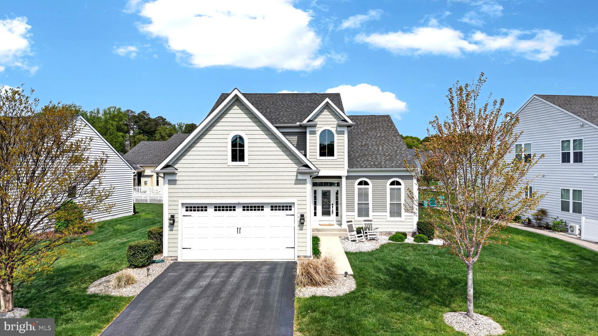 *Freshly painted basement and master bathroom* Luxury coastal living in the amenity-rich Grande at Canal Pointe (East of Route 1), just minutes from the Rehoboth Beach boardwalk and beaches. This expansive 5-bedroom, 4-bath single-family home offers approximately 2,786 sq ft above grade plus a 1,547 sq ft finished basement, delivering exceptional space and flexibility for year-round or seasonal living. Thoughtfully designed layout: A grand two-story foyer opens seamlessly into a spacious, light-filled living room with vaulted ceilings and a fireplace, creating an impressive central gathering space. The main level features two bedrooms, including a primary suite ideal for an in-law setup, along with a large den or office. Hardwood floors span the main living areas, and freshly painted common spaces enhance the home’s bright, open feel. The gourmet kitchen anchors the home with granite countertops, a large island, stainless steel appliances, pantry, and generous prep space. Upstairs, you’ll find two expansive rooms—one well-suited as a second primary suite—plus a large loft/bonus area ideal for a media room, recreation space, or additional lounge. The finished walk-out basement offers incredible versatility, featuring a massive family/recreation room, a full bath, and three additional rooms that can function as bedrooms, guest spaces, or flex areas for a gym or office. Outdoor living is equally impressive with a large paver patio, built-in firepit, outdoor shower, and irrigation system—perfect for entertaining or relaxing after a beach day. For added privacy, newly installed 5–6 ft arborvitae plantings will enhance the rear patio setting. A newer dual-fuel heating system provides efficient, year-round comfort. Community amenities include two pools, tennis, pickleball and basketball courts, a playground, shuffleboard, scenic ponds, and a canal-front nature area with kayak access. Enjoy direct access to the Breakwater Trail just one block away. Ideally located approximately 1.2 miles from downtown Rehoboth Beach, with convenient access to beaches, parks, shopping, and dining. This home offers the perfect blend of space, location, and coastal lifestyle—ideal as a primary residence, vacation retreat, or investment opportunity.