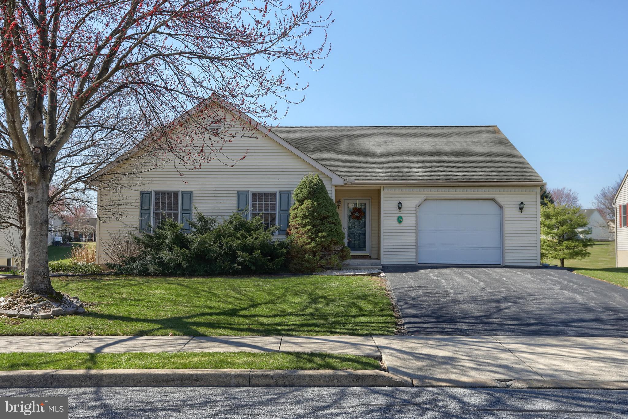 Welcome to 19 Springhouse located within Arbor Gate 55+ community.  No need to downsize here with a full walkout basement.  Bring your family heirlooms, collections, and treasures!  With (3) bedrooms and (2) full bathrooms, this residence offers functionality. Step inside to discover an inviting bright kitchen, complete with some gently used newer appliances. The main living area features a cathedral ceiling. Enjoy the sunroom (not included in the overall square footage - unheated space).  The primary bedroom has a generous sized walk-in-closet, and private bath with a step in shower.  Natural light pours in through double-hung windows, while ceiling fans provide a gentle breeze. The 3rd bedroom is small and would make a nice office.  It has a closet and a wall of built-in shelving to display your collections.  ROOM TO EXPAND in the WALK-OUT LOWER LEVEL.  Attention wood workers, crafters, quilters, collectors, entertainers....dream about making this lower level space your own.  NOTEABLE FEATURES:  Gas furnace and central air (2021),  some recent kitchen appliances, soaking tub with door and seat in second bathroom, and oversized 1 car garage with  added width + depth.  ABOUT THE NEIGHBORHOOD. Arbor Gate boasts excellent neighborhood features: lovely, picturesque tree-lined streets, sidewalks,  and street lights ensuring a safe, tranquil environment. As a resident of the Arbor Gate 55+ community, you’ll have access to amenities such as the Lakeview Clubhouse with a fitness room, coffee shop, library, billiards room, game room, weekly clubs, and annual events, fostering a sense of connection and engagement. The monthly land lease for 19 Springhouse Drive starts at $478.02 and includes: land taxes, on-site management, sewer, trash collection, bi-weekly recycling, access to Lakeview Clubhouse, common areas, and community lake. Schedule your tour today! Don’t miss this opportunity to enjoy a fulfilling 55+ active adult lifestyle in a welcoming community. Visit the neighborhood, take a walk, talk with the neighbors, and find out why so many have decided to call Arbor Gate home.