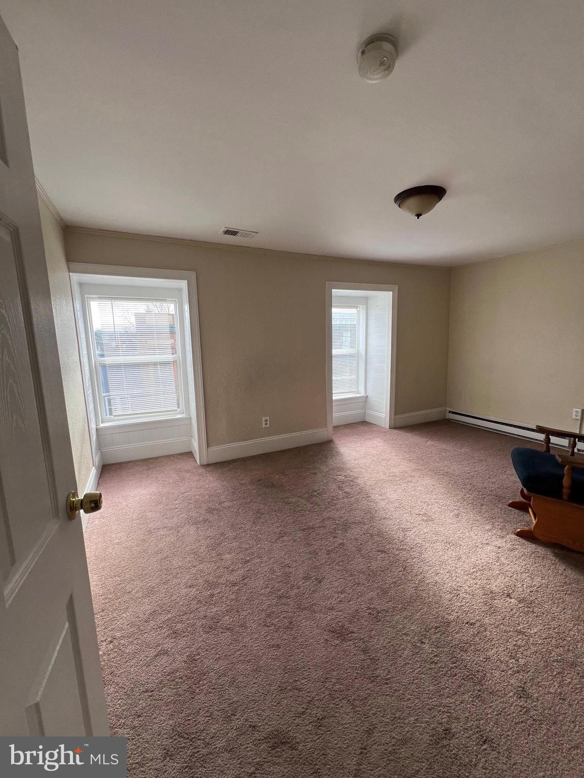 Large Spacious apartment located downtown on Washington St. This is a 2 bedroom apt with hardwood floors and carpet, nice views of the main street downtown.  No assigned parking, it is main street parking. Rent price includes water , sewer and trash. This apt does have central heat and air. No pets!!!