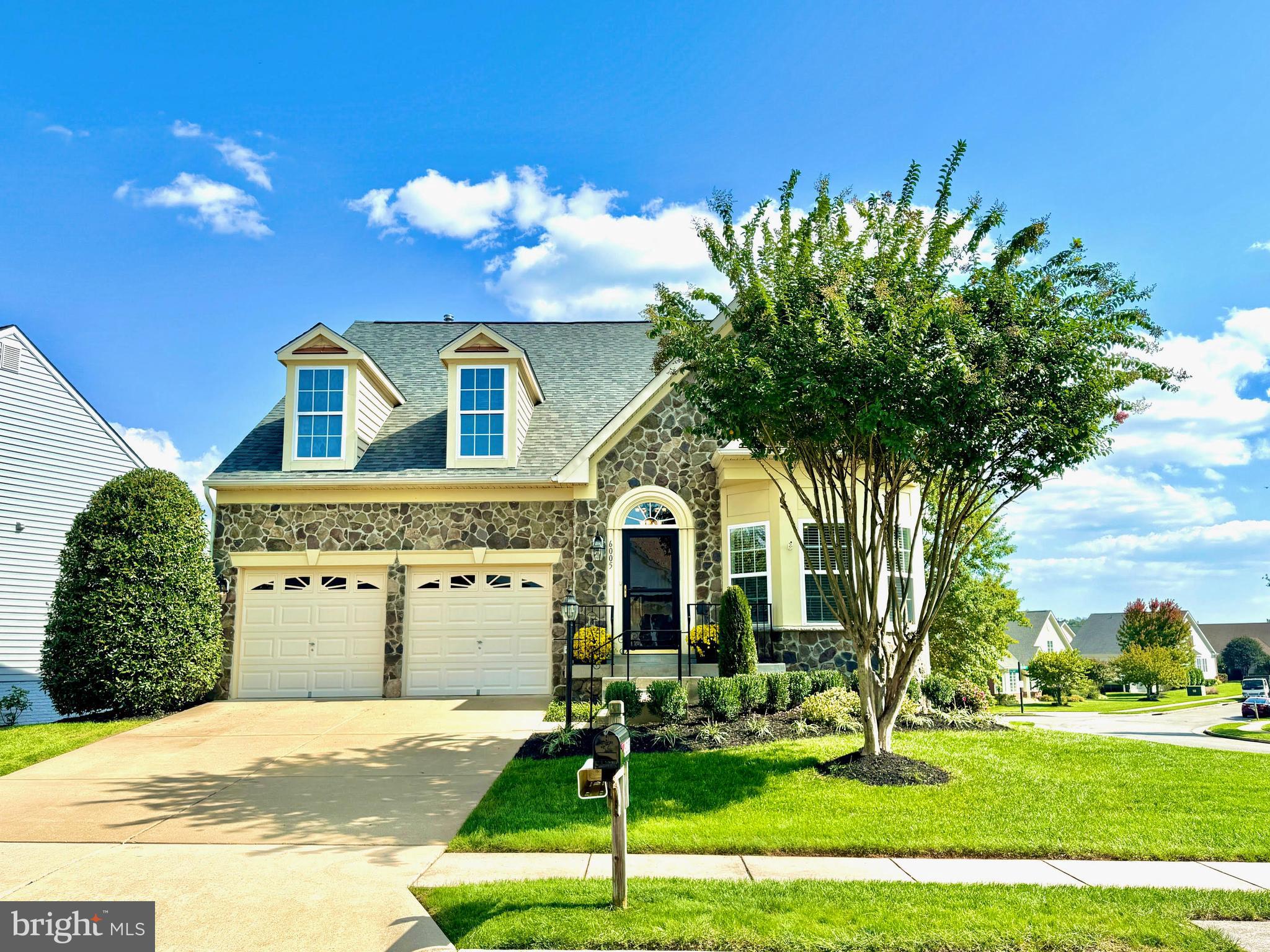 Welcome to 6005 Piney Grove Way, an exceptional residence in the award-winning 55+ gated active community of Heritage Hunt. Set within a premier golf course community spanning over 750 acres, this home offers resort-style living just minutes from I-66, Route 29, and the shops, dining, and entertainment of Virginia Gateway.   This beautifully maintained stone-front home, with stone wrapping the exterior, offers three finished levels, 4 bedrooms, and 4 full baths, enhanced by a significant addition that includes a spacious screened-in porch and an expanded walk-in closet in the primary suite.   A grand two-story foyer opens to a light-filled, open-concept main level featuring wide-plank hardwood flooring and a vaulted living and dining room anchored by a striking two-sided gas fireplace. The adjoining sunroom bump-out provides the perfect space to relax and take in the peaceful setting.   The gourmet kitchen is appointed with granite countertops, designer tile, and ample cabinetry systems, and flows seamlessly to the expansive screened-in porch, complete with skylights and stairs to the yard, creating an ideal indoor-outdoor living experience with minimal maintenance.   The main-level primary suite offers comfort and privacy with two large walk-in closets (including the recent expansion which lives like a dressing room or sitting room) and a spa-like bath featuring dual vanities, a large walk-in shower, and a built-in bench. A second bedroom and full bath on the main level provide flexibility for guests or a home office.   Upstairs, a versatile loft suite includes a walk-in closet and full bath. The walk-out lower level features soaring ceilings, a private bedroom suite with full bath, a spacious recreation room, and abundant storage with extra washer dryer hookups.   Additional highlights include two laundry areas, a finished and painted two-car garage with driveway parking, irrigation system, new landscaping (2024), new roof (2024), and new HVAC (2026).   Residents of Heritage Hunt enjoy an unparalleled lifestyle with access to two clubhouses, golf course, pool, on-site restaurant, and scenic walking trails—all within a secure, gated setting.   A rare opportunity to enjoy refined, low-maintenance living in one of Northern Virginia’s most sought-after active adult communities.