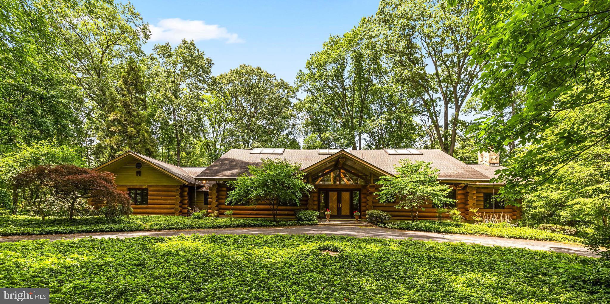Nestled on 68 breathtaking wooded acres in the heart of White Hall, this extraordinary log home offers unmatched privacy, natural beauty, and a true retreat-like setting. A winding approach leads to a one-of-a-kind residence where rustic craftsmanship and modern comfort blend seamlessly. Double entry doors welcome you into a dramatic foyer and soaring great room highlighted by cathedral ceilings, a raised-hearth stacked-stone fireplace, and french doors that open to a bluestone patio and  spectacular woodland views,  The expansive eat-in kitchen is designed for gathering and entertaining, featuring a center island, walk-in pantry, easy access to the formal dining room and a wet bar.  Pocket doors, custom millwork, and arched doorways throughout add character and timeless appeal. The main-level primary suite is a private sanctuary, complete with vaulted ceilings, a raised-hearth fireplace, built-in cabinetry, private deck access, a fitted walk-in closet, and a spacious bath. A second bedroom or den, full hall bath, mudroom, laundry room, and office complete the main level. The upper loft overlooks both the great room and foyer, providing an inspiring office or reading space.  The finished lower level offers two additional bedrooms, a full bath, cozy family room with built-ins, expansive recreation room, wine room, utility area, and abundant of storage space. Comfort is ensured year-round with five-zone radiant heating, an efficient Viessmann boiler system, and an infrared sauna for ultimate relaxation. Outdoors, the possibilities are endless. The property features established walking trails, abundant wildlife, exceptional birdwatching opportunities, seasonal wildflowers and a creek at the rear of the property that serves as natural spawning ground for trout.  A cleared acre-and-a-half area is ideal for equipment storage, wood processing, gardening, or hobby farming. Additional improvements include a workshop, storage shed, and ample space for other possibilities. Located in renowned horse country and near a local sporting and gun club, this remarkable property offers a rare combination of seclusion, recreation, and natural beauty. Whether you’re seeking a private retreat, hunting property, nature preserve, or full-time residence, this truly one-of-a-kind offering.