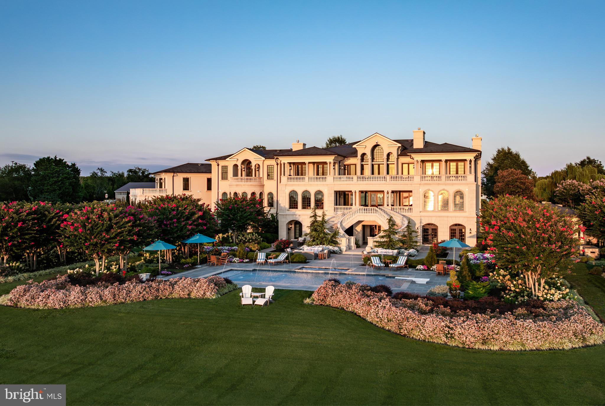 Commanding 18.67 private acres with sweeping views of the Chesapeake Bay and its iconic bridge, 200 Bridgeview Lane is a world-class waterfront estate of unprecedented scale and refinement. The residence harmonizes architectural grandeur with the serenity of coastal living.
 
Approached through a gated drive that unfolds past manicured lawns and sculpted gardens, the property immediately establishes a sense of privacy and prestige. Every detail, from the hand-forged ironwork to the precision of its stone craftsmanship, reflects a commitment to excellence that is timeless and enduring.
 
Inside, a dramatic double-height foyer reveals hand-milled trim, wrought-iron accents, and mahogany floors inlaid with imported stone. Expanses of glass capture 180-degree views of the Bay, drawing natural light into every corner and framing the horizon as a living work of art. Formal and informal living spaces flow effortlessly, united by coffered ceilings, bespoke millwork, and a sense of balance between grandeur and comfort.
 
The gourmet kitchen is an entertainer’s masterpiece, anchored by custom cabinetry, professional-grade appliances, and a central island designed for gathering. It opens seamlessly to the grand parlor and a series of multi-tiered terraces overlooking the Bay, surrounding a heated pool and spa. Beyond, an outdoor pavilion with a summer kitchen, bar, and cascading fountains sets the stage for unforgettable entertaining beneath open skies.
 
Occupying nearly 2,500 square feet, the primary suite serves as a sanctuary of peace and indulgence. It features a fireplace, sitting area, private office, and a terrace that captures sweeping water views. A spa-inspired bath with heated floors, dual vanities, soaking tub, and a marble shower complements a custom dressing room designed with meticulous detail. Each guest suite throughout the home is equally refined, offering its own private bath and distinctive character, ensuring every visitor experiences the same sense of thoughtful luxury.
 
From the home’s state-of-the-art amenities to its effortless connection to the Chesapeake, this is an estate conceived not only for living but for legacy.
 
Located just moments from Washington, D.C. and Baltimore, yet feeling worlds away, 200 Bridgeview Lane stands as a rare offering of seclusion, scale, and sophistication, where architectural artistry meets the infinite beauty of the Bay.