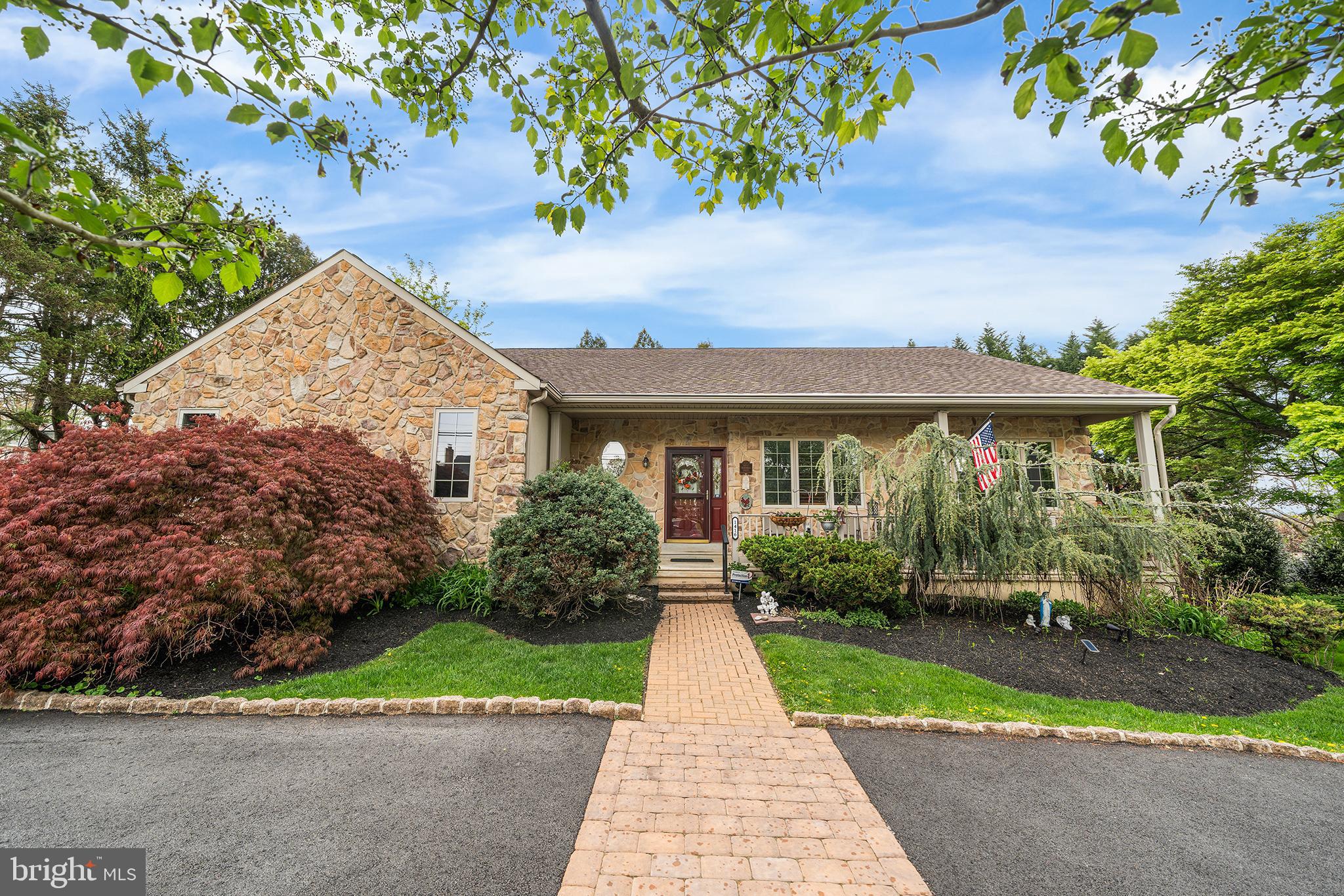 Welcome to this beautifully maintained stone-front residence, built in 2004 and thoughtfully designed as a raised ranch that blends comfort, warmth, and everyday functionality.

The main level opens into an inviting great room, kitchen, and dining area where natural light and an open-concept layout create an easy, connected flow. A striking stone façade propane fireplace anchors the space, while direct access to the rear deck extends living outdoors—perfect for quiet mornings or relaxed gatherings.

The primary suite offers a peaceful retreat with private access to a sunroom featuring a hot tub—an ideal space to unwind year-round. Two additional bedrooms and a full hall bath provide comfortable accommodations, along with a conveniently located laundry room and welcoming front porch entry.

The fully finished lower level adds versatility with additional living space, a second propane fireplace, and a third full bathroom—well-suited for guests, recreation, or a private home office.

Set on a lush .39-acre lot with mature greenery, the property offers a sense of privacy while remaining just a short walk to Conshohocken, nearby parks, and public transportation—bringing together a tranquil setting with everyday convenience.