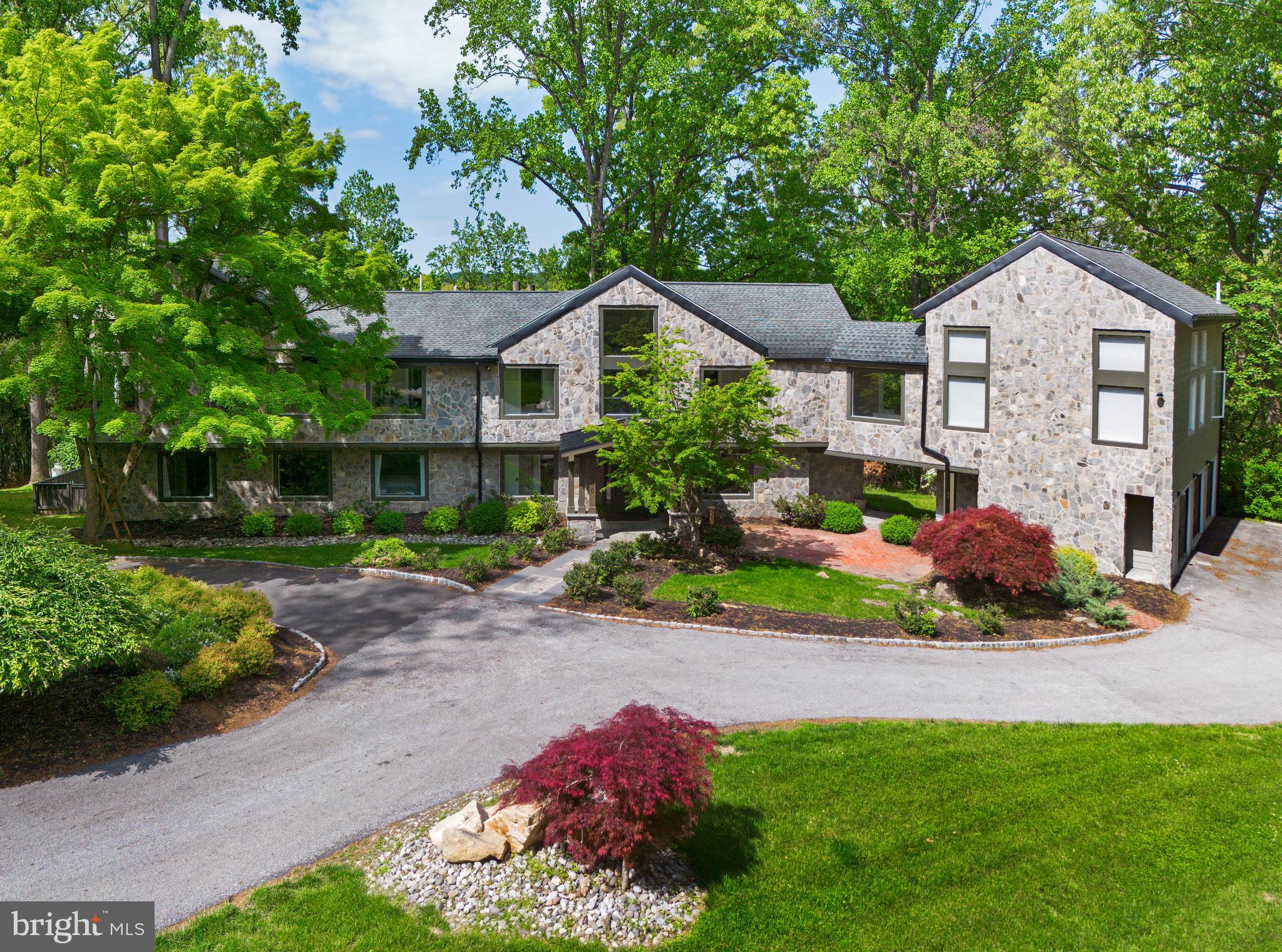 Stunning home on one of Penn Valley’s most desirable streets. Extensively renovated in 2019, this exceptional custom home offers 6 bedrooms, 7 full baths, and 1 half bath across more than 8,000 square feet of beautifully designed living space. Privately situated on a 2.78-acre interior lot, the home showcases a sophisticated transitional style, oversized windows, and wide-plank hardwood floors that have just been newly refinished.

A striking entry opens to an expansive, light-filled layout where the grand kitchen and dining area flow seamlessly into a breathtaking two-story great room. Featuring exposed beams, a dramatic floor-to-ceiling stone gas fireplace, and walls of glass, this space leads to a serene rear deck overlooking the landscaped grounds and resort-style pool.

The chef’s kitchen is both elegant and functional, complete with a massive quartz waterfall island, custom wood cabinetry, dual sinks, two dishwashers, and high-end stainless steel appliances. The main level also includes two bedroom suites with private baths, a dedicated office, and a powder room.

Upstairs, two luxurious primary suites provide exceptional comfort and flexibility. The main suite boasts vaulted ceilings, custom built-ins, a spacious walk-in closet, and a spa-like bath with dual vanities, soaking tub, and oversized shower. The second suite features vaulted ceilings, a lofted sitting area or office, walk-in closet, and a beautifully appointed bath with dual vanities and a large walk-in shower. This level also includes an additional bedroom suite, a full laundry room, and an expansive theater room with its own full bath.

The finished walk-out lower level offers incredible versatility, ideal for an au pair or in-law suite. With a private entrance, it includes a bedroom with walk-in closet, full bath, second laundry room, and a large recreation or playroom.

The lush, private grounds are perfect for relaxing or entertaining—whether enjoying the pool, dining al fresco, or unwinding on the patio. Complete with a 3-car garage equipped with an EV charger, this home offers both luxury and convenience. Located in the award-winning Lower Merion School District and just minutes from Narberth, Gladwyne Village, and major commuting routes to Center City, this move-in-ready residence is a rare opportunity not to be missed.
