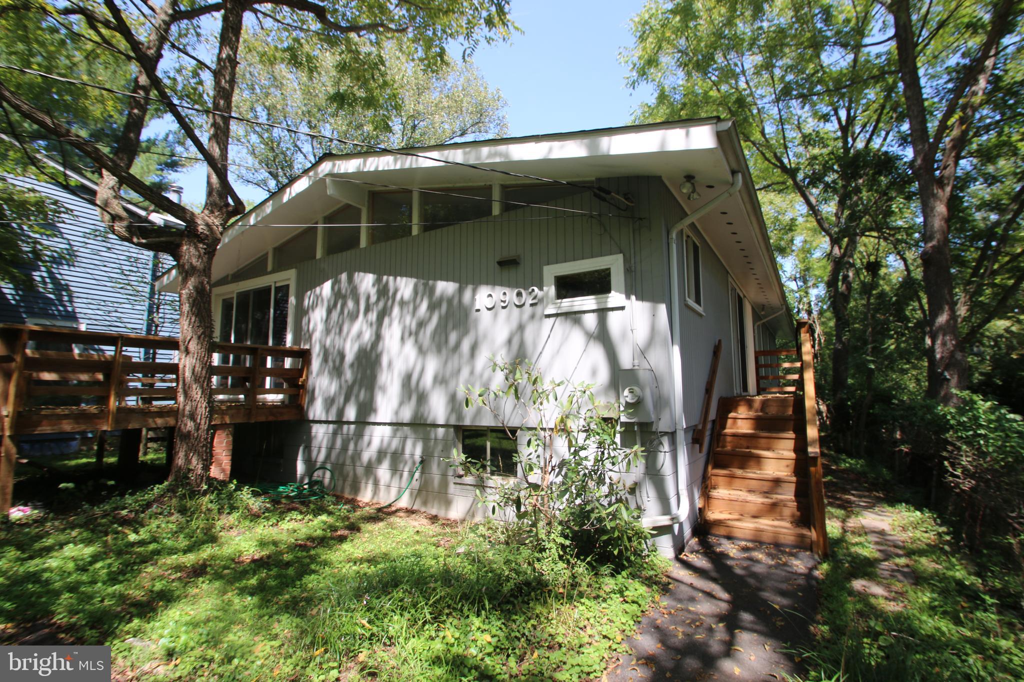 Rare Find in Sought After Garrett Park. Updated Kitchen, Vaulted Ceilings, Hardwood Floors, Brick Fireplace, Deck, Updated Electrical Panel, Some Updated Windows. Over 2,800 sq/ft on 2 levels! Lower Level is Mostly Unfinished, has High Ceilings and a Walk Out. This is a real gem, Just steps to the Pool, Parks, Marc, Metro, Etc! Must See!