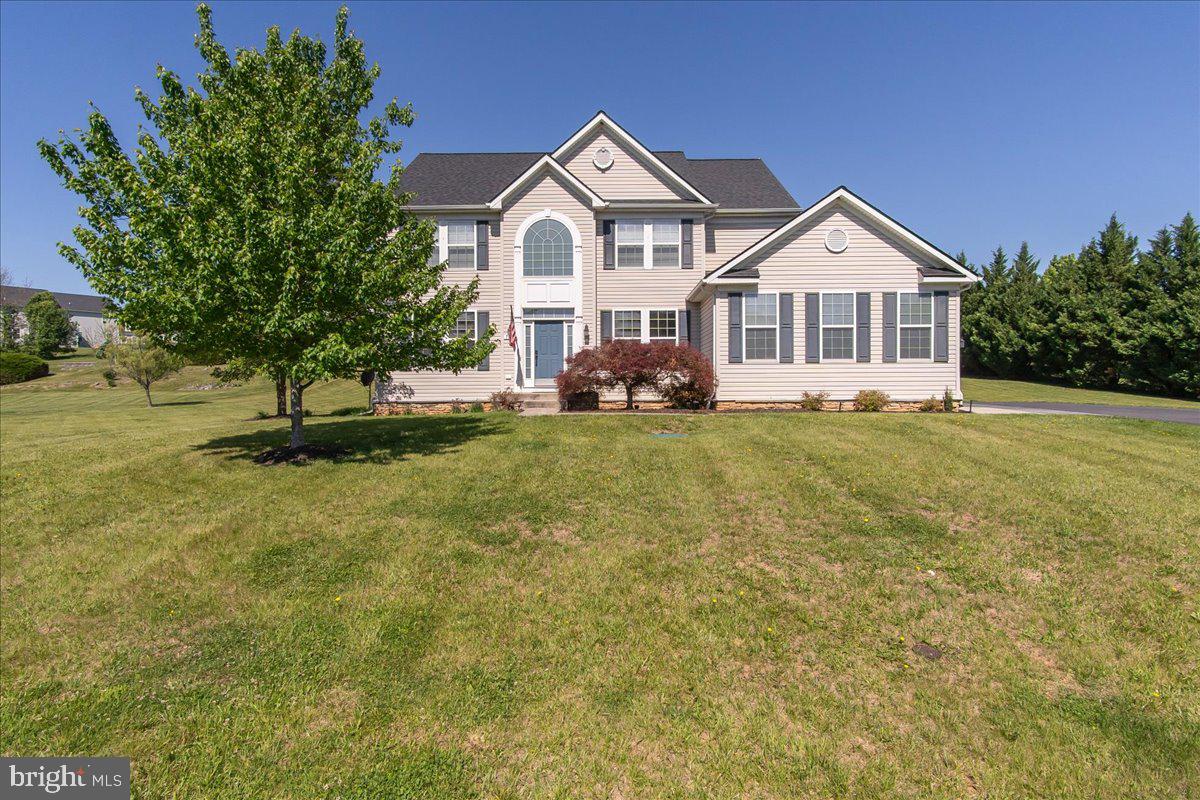 Tucked within the sought-after Ridges of Tuscarora community, this beautifully maintained and thoughtfully updated home sits on a peaceful one-acre lot and offers the kind of space, light, and layout that just feels right the moment you walk in. With over 3,100 square feet above grade and an additional 1,500+ square feet ready to be finished below, there’s room to spread out while still feeling connected. A soaring two-story foyer sets the tone, opening into a main level that is bright, open, and designed for the way you actually live. Hardwood floors have just been refinished and run throughout most of the main floor, while natural light fills every space. A private office sits behind double doors, and formal living and dining rooms offer flexibility depending on how you want to use the space—but it’s the kitchen and living areas where this home really shines. The kitchen is truly a standout—beautifully updated with quartz countertops, an oversized center island with bar seating, a stainless steel undermount sink, and an almost brand new full suite of Samsung smart appliances. It’s not just stylish, it’s incredibly functional, with generous cabinet and counter space and a layout that makes everything feel easy. It opens seamlessly into the morning room with vaulted ceilings and right into the spacious family room with a cozy gas fireplace. These spaces flow effortlessly together, creating a wide-open feel that’s perfect for everything from everyday routines to hosting friends and family. Control your blinds with the touch of a button, adding a simple, modern convenience throughout the main level. Upstairs, you’ll find four comfortable, well-sized bedrooms, including a primary suite that feels like its own retreat with vaulted ceilings, a large walk-in closet, and a fully renovated ensuite bath featuring a freestanding soaking tub, tiled shower, and dual vanity. The hall bath has also been beautifully updated, and all carpeting upstairs is BRAND NEW! Fresh interior paint and refinished stairs with wrought iron railings continue the home’s clean, updated feel. The unfinished lower level offers incredible flexibility with over 1,500 square feet, a double walk-up exit, and plumbing already in place for a future full bath—ready to finish now or down the road. Outside, the setting is just as inviting, with a spacious rear patio and an additional 15x30 patio with fire pit—perfect for relaxing evenings or gathering with friends. Major system updates include a new 50-year roof (2022) with transferable warranty, new garage door (2022), newer sump pump and well pump, commercial-grade water filtration system, two-zone HVAC, and dual 200-amp service panels. Turnkey, beautifully cared for, and truly move-in ready, this home offers a space that feels as good as it looks.