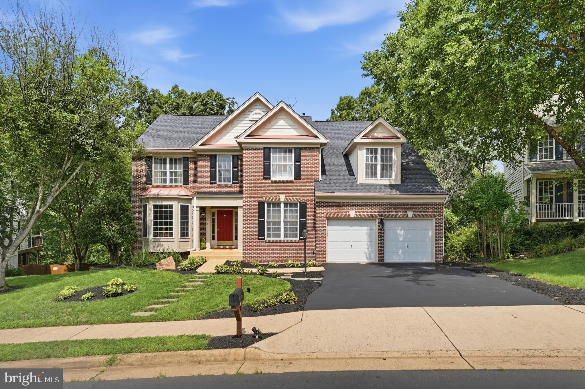 Welcome to this beautifully updated brick-front Colonial offering approximately 4,238 square feet of finished living space across three fully finished levels. Thoughtfully designed for comfort, functionality, and entertaining, this exceptional home features 5 LARGE bedrooms, 3.5 bathrooms, a two-car garage, a private OFFICE, a dedicated DEN, a spacious FAMILY room, a RECREATION room, and a desirable open floor plan.

Step inside the dramatic two-story foyer, where soaring 10-foot ceilings on the main and lower levels, abundant natural light, and elegant formal living and dining rooms create a welcoming first impression. The inviting family room flows seamlessly into the gourmet kitchen, complete with abundant cabinetry, a pantry, generous counter space, updated lighting, and newer stainless steel appliances.

Fresh interior paint, beautiful hardwood flooring, and (LVP) luxury vinyl plank flooring enhance the home's warm, modern feel. Upstairs, the spacious primary suite serves as a private retreat, featuring vaulted ceilings, hardwood flooring, oversized windows overlooking the wooded backyard, space for a sitting area, and direct access to the luxurious renovated en-suite bathroom. The spa-inspired bath offers a freestanding soaking tub, oversized frameless glass walk-in shower with dual shower heads and a built-in bench, dual vanities with abundant storage, elegant tile finishes, and a vaulted ceiling with a skylight that fills the room with natural light. The additional bedrooms provide flexibility for family, guests, or home office space.

The fully finished walk-out lower level adds exceptional versatility with a spacious recreation room, a fifth bedroom with a walk-in closet that is ideal for an in-law suite or guests, a full bathroom, and additional flexible space plus a LARGE DEN with a closet perfect for a home gym, office, or hobby room.

One of the home's most desirable features is its exceptionally private backyard. Backing to mature trees with no homes directly behind, this peaceful setting offers a rare sense of privacy. Enjoy morning coffee on the deck, host family and friends, or simply unwind while taking in the tranquil wooded views.

This home has been meticulously maintained and thoughtfully updated over the years, including:

2026: Professional landscaping, power washing, deck professionally cleaned and stained, plus the house has been professionally cleaned.  

2025: New luxury vinyl plank flooring, fresh interior paint, updated lighting fixtures, Painted Kitchen cabinets, and new door knobs and hinges throughout.

2023: New architectural roof. 

2022–2025: New stainless steel kitchen appliances. 

2020: New upper and lower HVAC systems, hardwood flooring, and a new deck. Renovated Bathrooms: Beautifully updated primary bathroom, hallway full bathroom, and main-level powder room

Ideally located near shopping, restaurants, parks, walking trails, VRE stations, and major commuter routes, this move-in-ready home offers the perfect combination of generous living space, quality updates, and a private wooded setting.