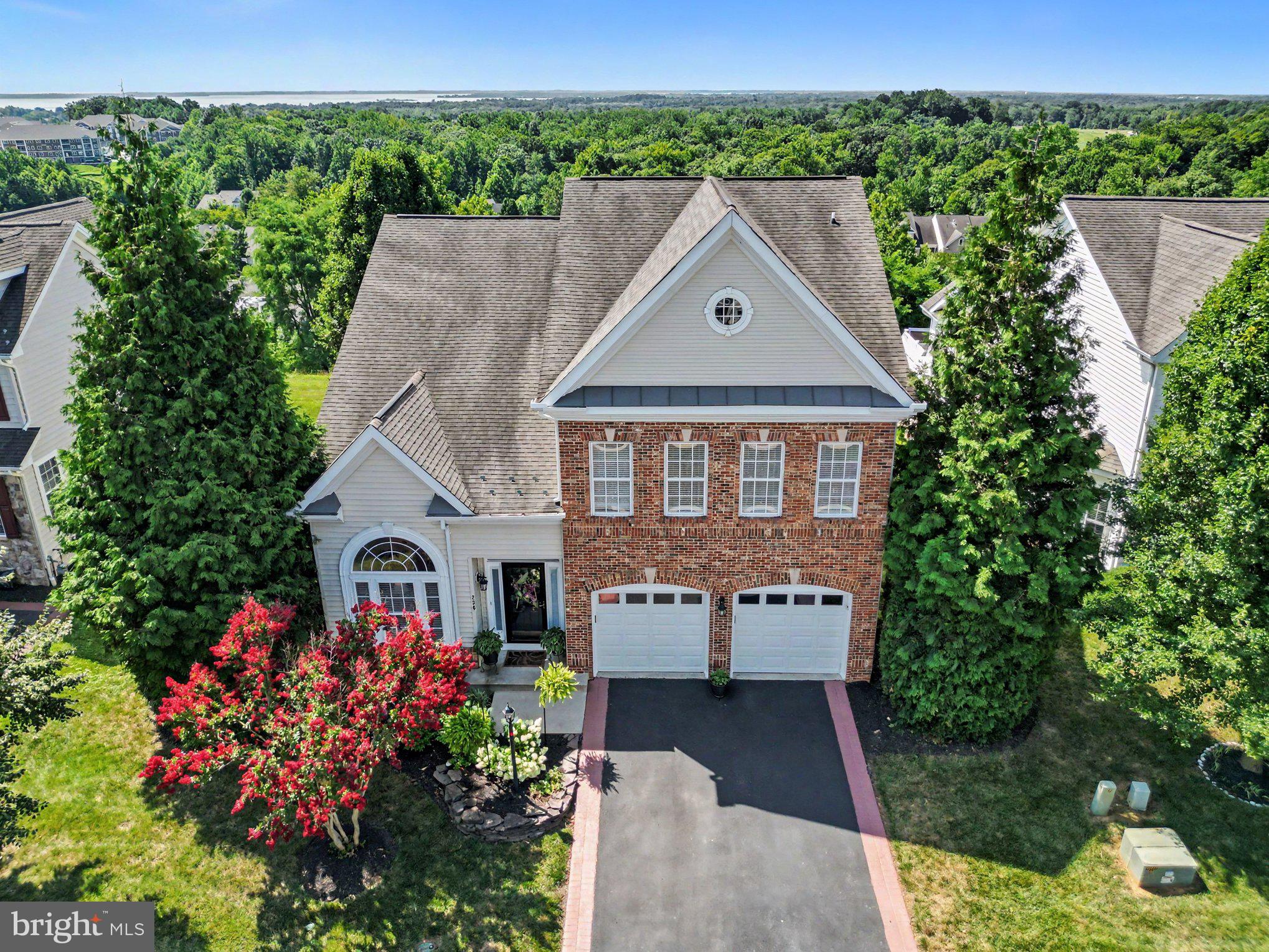 Experience sophisticated single-level living at 236 Smarty Jones Terrace, a beautiful detached colonial in the Bulle Rock community. The home greets you with vaulted ceilings and hardwood floors in the formal living and dining areas, flowing seamlessly into an updated gourmet kitchen. This recently updated culinary space is perfectly equipped with stainless steel appliances, white cabinetry, a gas cooktop, a walk-in pantry, and a large central island with pendant lighting. From the adjacent family room, step out onto the expansive 30' x 13' elevated composite deck. This fantastic outdoor space is perfect for entertaining, offering scenic, panoramic views of the surrounding area and views of the Chesapeake Bay. The main-level primary suite serves as a luxurious retreat, complete with a walk-in closet and a remodeled en-suite bath featuring a frameless glass shower, dual vanities, and a corner soaking tub. The main floor also includes a den/office with a curved transom window, a second bedroom, a full bathroom, and a laundry room. Upstairs, you will find a versatile loft and a private third bedroom suite. Finally, a massive 1,700+ sq ft unfinished walkout basement with French doors leading to dual paver patios offers incredible potential for future expansion. The prestigious, gated Bulle Rock community offers a luxurious, low-maintenance lifestyle where the HOA takes care of tasks like lawn mowing and snow removal. At the heart of the neighborhood is the spectacular 37,000-square-foot Residents' Club, which boasts indoor and outdoor swimming pools, a 3,200-square-foot fitness center, a billiards room, a business center, and a café. Outdoor enthusiasts will love the lighted tennis and pickleball courts, the five-mile walking trail that winds through 200 scenic acres, and the world-renowned, Pete Dye-designed Bulle Rock Golf Course, complete with its own Gourmet Pub & Grill. To top it all off, a full-time Lifestyle Director coordinates a wide variety of resident clubs, monthly happy hours, and social events, ensuring there is always something exciting to do.