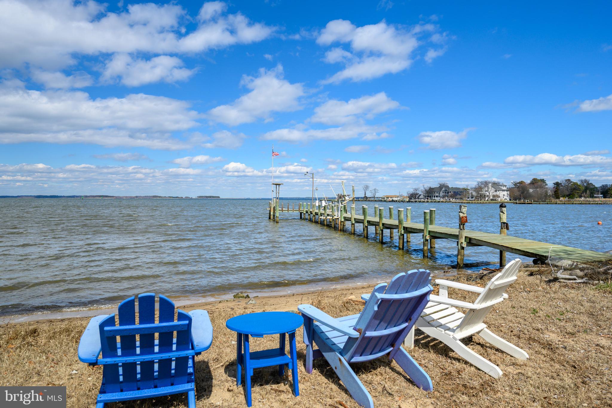 Expansive views stretch along Jackson Creek to the Chester River, creating a waterfront setting that is truly exceptional. For anyone who loves life on the water, this property offers a rare opportunity, complete with a sandy beach and impressive waterfront frontage. The outdoor amenities are designed for both relaxation and recreation, including a pier with boat lift and electric, a beach house cabana, pool, pergola, hardscape, and plenty of space for poolside entertaining.

Natural light fills the home from sunrise over the Chester River throughout the day as the sun moves west. The main house is in excellent condition and offers multiple living spaces, including three sitting areas, a breakfast room, and a formal dining room. Beautiful finishes include hardwood floors, cherry kitchen cabinetry, stainless steel appliances, and a beverage bar. A stone fireplace adds warmth and ambiance to the open living areas.

The home features five bedrooms, three full baths, and one-half bath, with hardwood flooring throughout both levels. A first-floor bedroom with a full bath provides flexibility for guests or multigenerational living. The primary suite is ideally positioned on the waterside and includes a private balcony. An indoor porch, outdoor porches, and a game room make this home especially well-suited for entertaining.

Surrounded by mature trees, the property also offers a spacious yard with fencing already in place for children and pets.