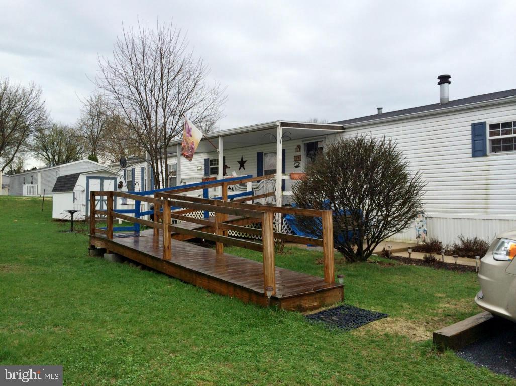 OVER 55 Community, enjoy quiet retirement living in this COUNTRY COZY singlewide. 2000 Champion (by Liberty) 16x76 with ramp access and covered porch. AVAILABLE FOR SEPT 1 OCCUPANCY. Stained glass & tiffany lighting fixtures are reserved by Seller. Wood shutters in kitchen stay. Water softener stays. Equipped with heat detector/smoke alarms and 6 ceiling fans! See 31 pics. Small dogs OK.