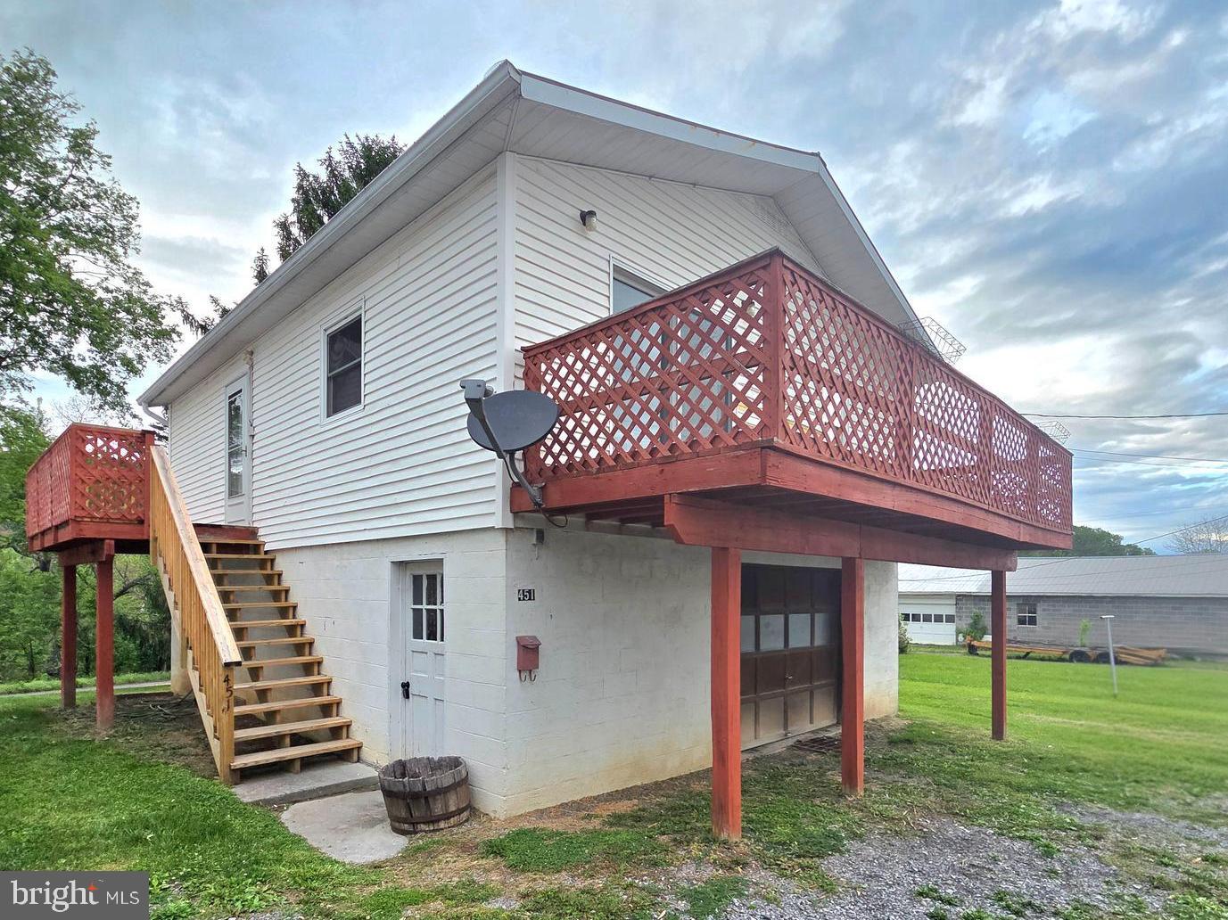 Single family home over a full 700+ sqft garage! Great for 1st time home buyers or Investors 2 bedroom dwelling  over garage, large 12x15 kitchen, living rm, 2 bedrooms and full bath. all new windows recently put in,12x15 sqft living room with sliding doors leading to 7x24 balcony deck, new 2 tier deck with steps  minutes to town conveniences, attached oversized garage with washer & dryer, toilet & sink, double liner stainless steel flue for wood, pellet, or gas stove 200 amps, over 700 sq ft in garage (separately metered) from living quarters,  24 hr notice to show.  
Seller is offering adjoining property MLS # WVHS2006254 for a combined purchase Seller offering 5,000 credit, toward repairs or closing cost with a full offer.