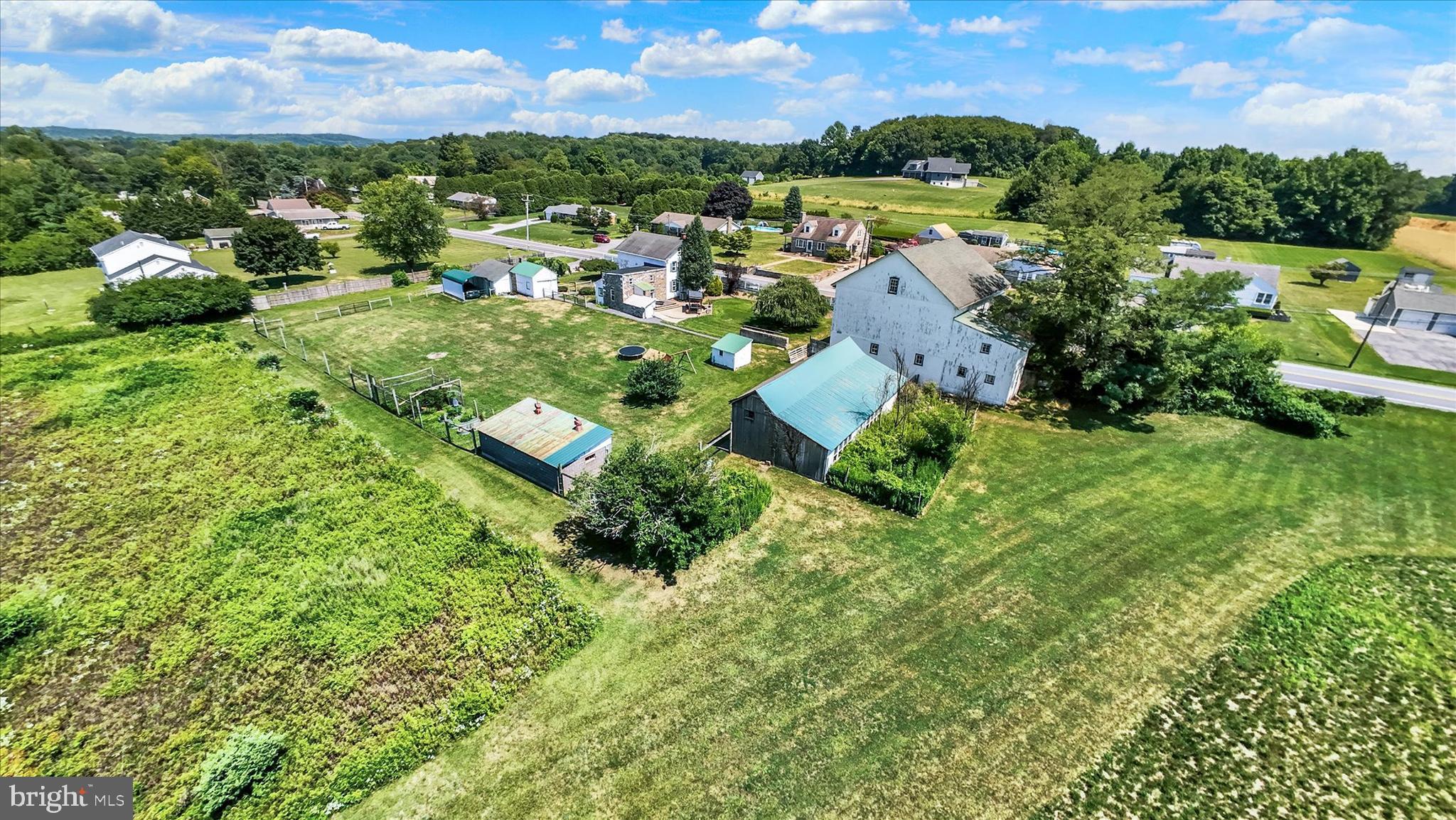 Step back in time without sacrificing modern comfort at this beautifully maintained 1800s farmhouse nestled on over 5.5 usable acres in the sought-after Oley Valley. Offering 3 bedrooms, 1.5 bathrooms, and 2,411 square feet of thoughtfully updated living space, this home perfectly blends historic character with today’s conveniences.
From the moment you arrive, you’ll appreciate the timeless charm that only a home of this era can offer. Original architectural details have been preserved while the current owners tastefully updated the home providing comfort and peace of mind. Recent improvements include newer central air, furnace, hot water heater, and electrical system, allowing you to enjoy the home’s rich history without the worry of major mechanical upgrades. Public sewer service adds another layer of everyday convenience.

Outside, the possibilities are endless. The property features mostly open fields with a wooded backdrop, creating the perfect setting for hobby farming, animals, gardening, or simply enjoying the land. A charming two-story bank barn stands as the centerpiece of the property followed by several outbuildings including, a large chicken coop, a workshop, and a detached two car garage with a storage shed/shop in the rear and more. With no shortage of space for equipment, hobbies, or business needs, the outbuildings are even separately metered for electric, offering added flexibility for future use.

This property remains conveniently located just minutes from major routes, making commuting and everyday travel remarkably easy. Whether you’re looking for a charming homestead, space to pursue your passions, or simply a property with unmatched character and functionality, this exceptional Oley Valley farmhouse is ready to welcome you home.
