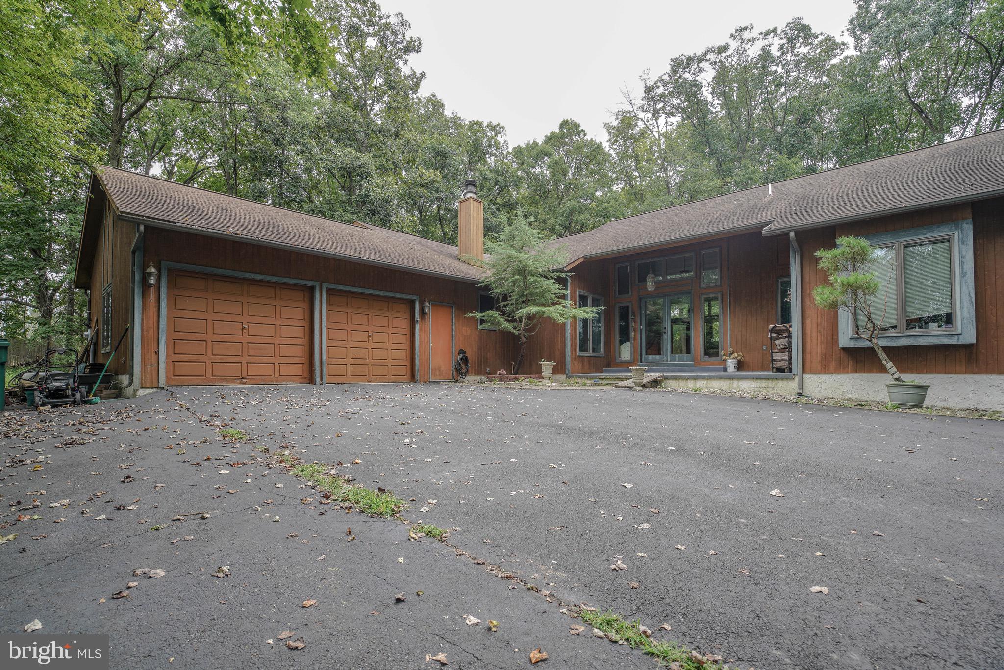 A beautiful 10+ acre property at a competitive price, this spacious, ranch is the comfortable country home you are waiting for! The main entrance opens to a high-vaulted living room with a cast-iron wood stove and lush views of the forest through large windows and glass doors. The enormous master bedroom suite features two walk-in closets, a vanity sink, and a master bathroom with a hot tub also overlooking the woods. Two smaller bedrooms - great for kids, guests, or as an office - are next to the 2nd full bathroom. A spacious, white-washed kitchen has ample counterspace and is adjacent to an open-floored dining area. All features of this property are in excellent mechanical condition - updates include new septic system pumps and filters, a new garbage disposal, and a new hot water heater to be installed in August 2019. Situated within a mile from Nockamixon State Park, there are numerous outdoor recreational opportunities - hiking, horseback riding, boating, hunting, and much more. Located in the award-wining Palisades School District and close to a main road, this location is ideal and central to the Delaware and Lehigh Valley areas.