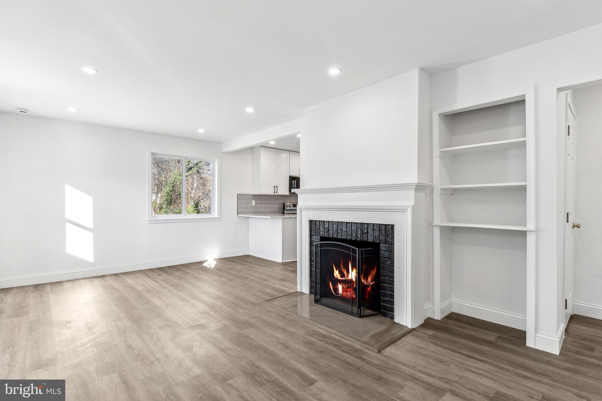 This updated home features new windows, HVAC, appliances, and hardwood floors. Enjoy a sun-filled living room with a cozy fireplace, a modern kitchen, and three spacious bedrooms. The finished basement offers flexible space, and off-street parking adds convenience. Relax or entertain in the fenced backyard with patio and firepit. Ideally located near shops, dining, and transit—this home blends style, comfort, and location. Don’t miss it!
