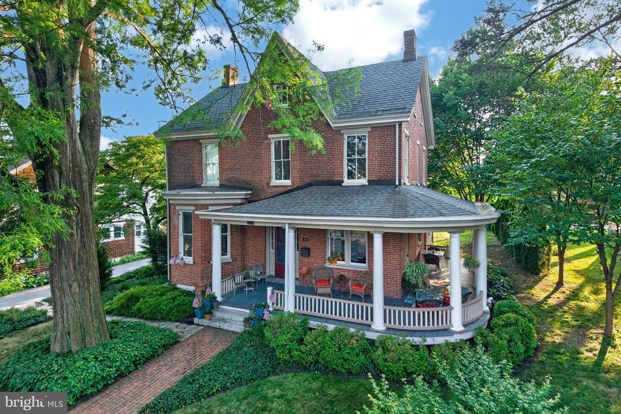 Step back in time with "Cypress Lawn," a stunning historic home built in 1873 by Samuel and Deborah Pennock. Situated on a spacious .68-acre lot within walking distance of downtown Kennett Square, this beautifully maintained property blends timeless character with modern updates. Offering 4 bedrooms, 1.5 bathrooms, 11-foot ceilings, hardwood floors, custom moldings, and abundant natural light, the home has been freshly painted throughout and is move-in ready. The completely remodeled kitchen and full bathroom provide today's conveniences while preserving the home's historic appeal. A welcoming wraparound porch overlooks the mature trees that provide shade and privacy. You can entertain guests in the dining room which is located next to the great room. Following out into the hallway brings you to the study which is currently being used as an office. The kitchen features an induction range, butcher block center island, full height cabinets, and soapstone counters. The first floor also includes a convenient half bath and an attached one-car garage. Upstairs, you'll find four generously sized bedrooms with ample closet space and a centrally located full bath. The finished walk-out basement features a cosy family room with a gas fireplace, a well-appointed laundry room, space for arts and crafts, multiple storage areas, and walk-up access to the backyard. Updated mechanicals include high-efficiency gas heat and hot water, plus central high-velocity air conditioning. The third floor offers two additional unfinished rooms with a storage room between them, presenting an excellent opportunity to create additional bedrooms, office space, or a bonus room. Car enthusiasts, hobbyists, and contractors will appreciate the impressive 36' x 48' detached garage with insulation, heat and water that also accommodates a vehicle lift. This is a rare opportunity to own a piece of Kennett Square history with modern comforts, exceptional garage space, and a prime Borough location.