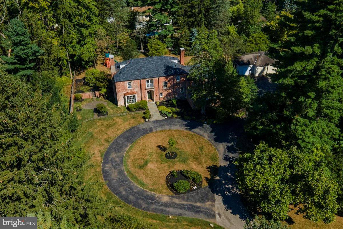 Classic brick manor home situated on a prime one and a half+ acres on a private cul-de-sac in Villanova which has undergone extensive updating over the last 2 years.  Originally built  for the Clothier Family of Philadelphia this home is filled with charm and light and wonderful architectural details. Drive down the impressive circular driveway to the brick covered wood front door. The encapturing front entrance hall features an enchanting curved staircase with Palladian window overlooking the front grounds. The entrance hall also leads to the large formal living room with newly  refinished  random width pegged floors,  new bay window and newly relined elegant fireplace with wonderful views of the front, side and rear yards which have just been fenced  The entrance hall leads to an inviting study with access to a private patio newly enlarged with fresh slate and the entrance to the large stately dining room which adjoins a country kitchen and breakfast room with outside entrance to the rear driveway and two-car garage. A Private powder room is tucked under the front stairway. Laundry area and back staircase complete this level. The second floor features a large primary suite with private bath and walk-in closet and wonderful views of the beautiful grounds. Second bedroom/office with hardwood floors features a large picture window with views of the front grounds. There are two spacious bedrooms with a Jack and Jill bath in the main section of the house. The original servant's quarters featured two bedrooms which has just been converted into 1 large bedroom with a new hall bathroom and access to the back stairs. there is a lot more to this home that has been updated.
