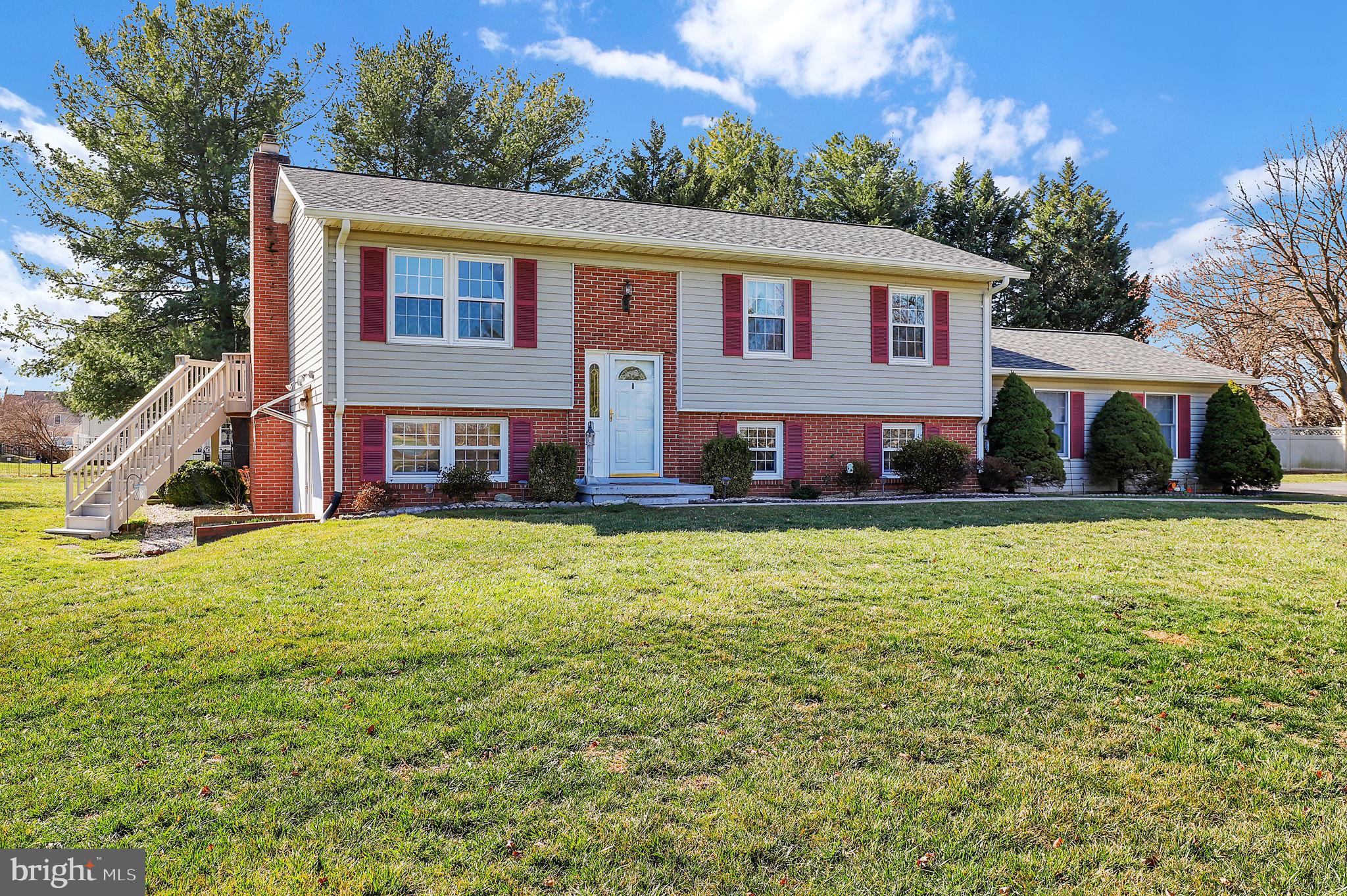 If you're searching for privacy and a peaceful setting in Adamstown, this is the one. Nestled on nearly one acre and set back from the road, this classic 1979 split foyer offers the perfect blend of comfort, functionality, and outdoor living.  The home features 4 bedrooms and 2 full baths, along with an oversized two-car garage. Inside, a cozy gas fireplace creates a warm focal point for gathering and relaxing. In 2015, the windows were replaced with tilt-in models for easy cleaning and improved efficiency.  Outdoor living truly shines here. Enjoy morning coffee or evening sunsets on the lovely covered sun porch, and take advantage of the additional deck area for grilling and entertaining. The expansive side yard provides room to garden, play, or maybe add a pool. The property also includes two storage sheds plus a small fenced area for added versatility. A recently repaved driveway enhances both curb appeal and everyday convenience.  With its generous lot size and thoughtful maintenance over the years by the original owner, this home offers the opportunity to enjoy quiet living while still being within easy reach of everything Frederick County has to offer.