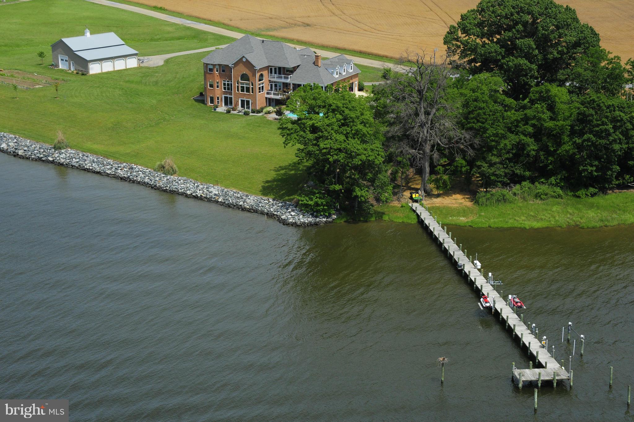 All brick custom home on 3.5 acres of deep  waterfront on St. Clements Bay.pier with 4 lifts and water and electric and interco over 600 ft of waterfront.waterfront with sunsets like no where else. heated. inground pool and screen porch with fireplace. this home was built for entertaining with views from everywhere. watch the sun rise over the farm and watch the sun set over st clements bay