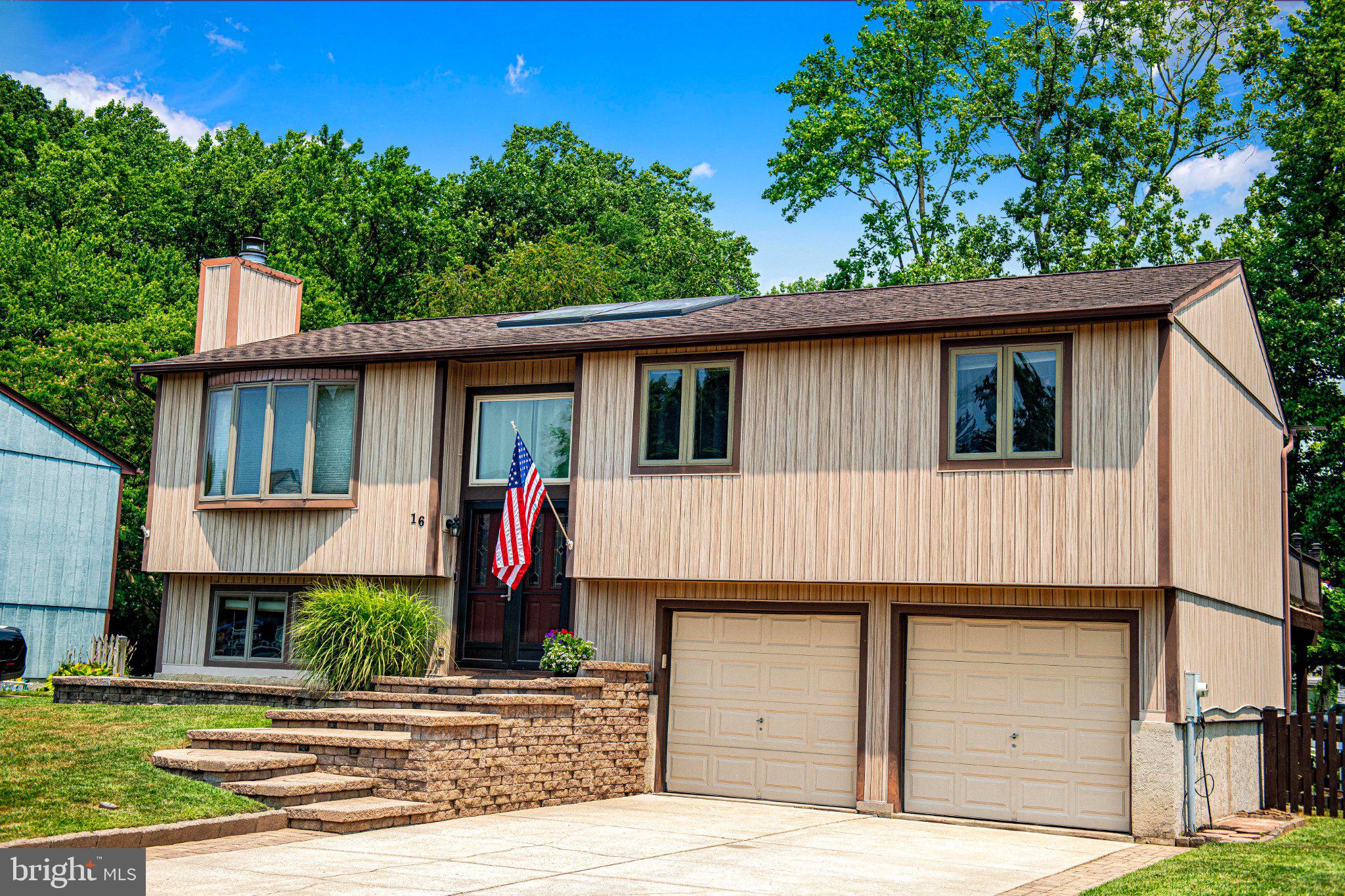 OPEN HOUSE Saturday 7/25 12-2! Welcome to one of the best-kept secrets in Essex! Nestled in the highly desirable, water-oriented community of Sue Creek Landing, homes in the rear section of the neighborhood rarely become available. In fact, this is just one of five homes to be offered for sale in this section of the community over the past 2.5 years!

Tucked away on a quiet cul-de-sac, this stunning home showcases a timeless coastal-inspired design with abundant natural light, beautiful architectural details, extensive trim work, and charming finishes throughout. The open-concept main level is designed for both comfortable everyday living and effortless entertaining. The beautifully appointed kitchen features stainless steel appliances, breakfast bar seating, space for a dining table, and a striking vaulted wood-planked ceiling that creates warmth and character. The kitchen flows seamlessly into the family room and the light-filled sunroom, offering exceptional flexibility. Whether the sunroom is used as an additional family room, morning room, playroom, home office, or peaceful reading retreat, this space is sure to become a favorite. Sliding doors open to the expansive rear deck, creating the perfect indoor-outdoor lifestyle.

The upper level offers generously sized bedrooms, including a spacious primary suite featuring a custom wainscoting accent wall with a display shelf—perfect for showcasing artwork, photographs, or seasonal décor. The private ensuite bath includes a walk-in shower, while the hall bath offers an oversized vanity and generous space for family and guests.

The finished lower level offers a spacious recreation room centered around a cozy wood-burning fireplace, additional bead board trim accents, and a versatile bonus area ideal for a home office, craft room, fitness space, playroom, or whatever best suits your lifestyle.

Additional highlights include multiple skylights that flood the home with natural light, pretty laminate flooring, a large bay window, attractive paver hardscaping, an oversized garage with built-in storage, and coastal-inspired vinyl siding that offers the vibe of wood without the maintenance.

Outdoor living is where this home's heart is. The impressive deck provides endless opportunities for entertaining, from summer cookouts and crab feasts to morning coffee and evening cocktails. The shaded patio offers a private retreat that's perfect for additional seating or the ideal location for a future hot tub. Beneath the deck, you'll also find a convenient storage shed with ample room for lawn equipment, bicycles, and other outdoor gear. The fully fenced backyard provides plenty of space for pets, gardening (there is a raspberry bush!), play, and outdoor enjoyment.

Enjoy glimpses of Sue Creek from both the front and backyard, offering a preview of the relaxed, water-oriented lifestyle that makes this community so special. Just 1-2 blocks away, you will get to enjoy exclusive access to the community's private waterfront park featuring a pier, boat launch, picnic tables, benches, grilling stations, and a kayak/canoe launch. Whether you're launching your boat or a kayak, casting a line, gathering with family/friends for a waterfront picnic, or simply enjoying a peaceful evening by the water, Sue Creek Landing offers a lifestyle that's hard to find.

For added peace of mind, the HVAC system was replaced approximately in 2020, new washer/dryer 2020, recent kitchen appliances, and the home also features an owned solar-powered hot water heater.

Offering thoughtfully designed living spaces, exceptional outdoor entertaining areas, and the rare opportunity to live in one of Essex's most sought-after water-oriented communities, this is more than just a home—it's a lifestyle you'll love coming home to!

Some photos are AI Staged/Enhanced.