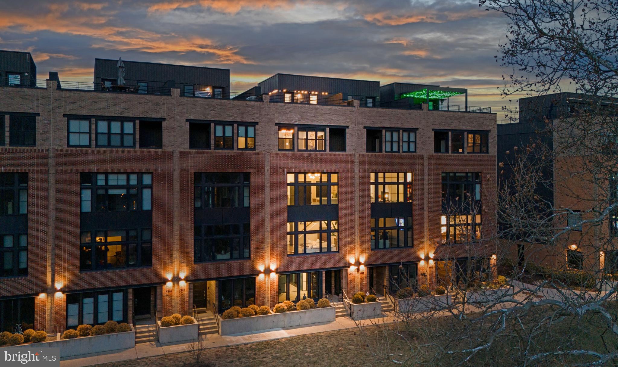 Welcome to Unit 4582, a masterpiece of modern luxury in The Locks at Manayunk, offering breathtaking, unobstructed river views and an effortless blend of elegance and convenience. Set within this premier riverside enclave, this townhome provides a tranquil retreat while placing you within easy reach of Main Street’s vibrant dining, the historic Manayunk Canal Path, and the train for seamless city access. Spend your day exploring Manayunk’s boutiques and restaurants, an end it with unforgettable sunsets from your private rooftop deck. Inside, sophistication meets smart living with four bedrooms, 3.5 baths, and a suite of high-end amenities, including a Savant smart home system, Lutron lighting and window treatments, a 4K ultra-HD projector, a five-stop elevator, and an integrated sound system. The sunlit first floor sitting area with custom built-ins and serene river views offers a perfect lounge space, while the expansive two-car garage provides ample storage. The main living area is designed for both everyday luxury and grand entertaining. Wall-to-wall windows flood the space with natural light, while the upgraded kitchen boasts custom shaker-style cabinetry, Wolf six-burner range, Sub-Zero refrigerator,  oversized quartzite island, walk-in pantry, and a built-in beverage fridge. The living area showcases stunning water views, enhanced by an ultra-HD projector and hidden theater screen, complemented by Lutron UV-blocking shades that adjust at the touch of a button. The third floor features a serene bedroom suite with fantastic river views, dual walk-in closets, and an en-suite bath. Two additional bedrooms—one currently a refined office—share a well-appointed hall bath, along with a convenient laundry room. The fourth-floor primary suite is a private sanctuary, complete with Lutron blackout shades, a spacious walk-in closet, two additional closets, and a private balcony overlooking the river. The luxurious spa-inspired bath boasts dual vanities, a marble walk-in shower, and a deep soaking tub, while a cozy sitting area and beverage center complete the suite. Atop it all, the spectacular rooftop deck with Ipe wood decking, integrated lighting, and a premium sound system delivers panoramic views of the Schuylkill River and Manayunk’s skyline. This home is situated above the floodplain, and flood insurance is not required. With four years remaining on the Tax Abatement, and a location steps from Main Street, the Schuylkill River Trail, and I-76, Unit 4582 isn’t just a home—it’s a lifestyle.