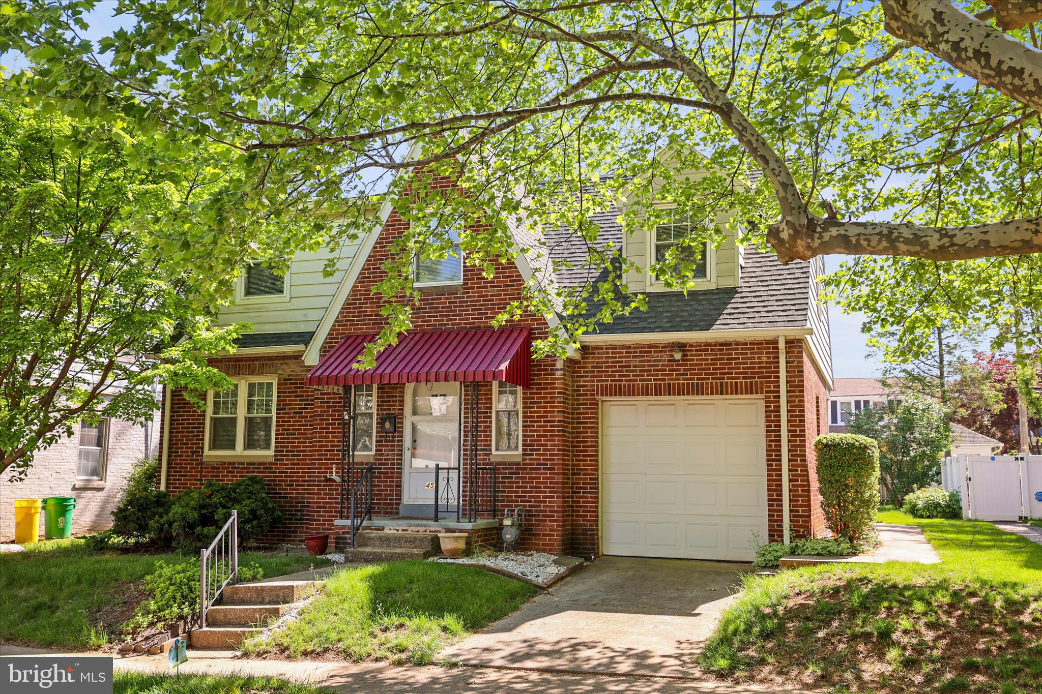 Adorable brick cape cod on a beautiful tree lined street  has been well maintained is ready for a new owner.  Three nice sized bedrooms and 1 full bath on the second floor and there is a large living room with a brick fireplace, formal dining room and an eat-in kitchen with a cute breakfast bar.  Beautiful hardwood floors throughout the home. There is an attached one car garage and a driveway parking for one car.  The backyard is fenced and private plus there is a covered back porch for relaxing.  The basement is unfinished with plenty of storage space plus the laundry with a washer and dryer included.  Updated gas water heater plus 3 window AC units are included.  Come check it out before it is gone.  James E. Gross Park is only a block away.