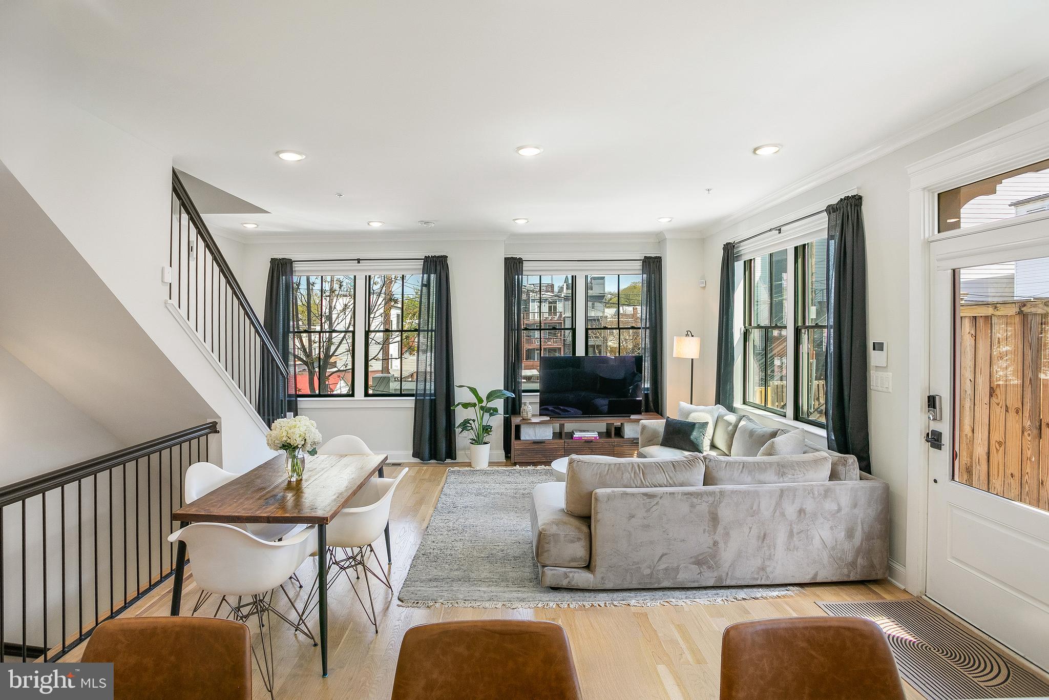 Built in 2021 and meticulously maintained, Unit 5 spans 2,222 square feet across four levels, with 4 bedrooms, a large den, and 3.5 baths, plus a 200-square-foot rooftop deck and a specification list that genuinely sets it apart. All the benefits of new construction, without the wait.

The main floor is bright and completely open, accessed through the unit's private entrance off the building's promenade. The kitchen is the reason people linger, with handmade cabinetry featuring walnut drawers and shelves, quartz countertops, a Bosch refrigerator and dishwasher, and a KitchenAid range. A convenient half bath completes the level.

The entire second floor is the owner's suite, featuring an oversized walk-in closet outfitted with a full Elfa system. The marble-clad bathroom is spa-caliber: dual vanities, a linen closet, a curbless wet room, and a freestanding soaker tub. The LG washer and dryer live on this floor as well, right where you need them: steps from the closet and bedroom rather than a separate trip downstairs.

The third floor holds two additional bedrooms, each with a walk-in closet. Beneath a skylight, a wet bar with a wine fridge sits adjacent to the roof deck access and a full bath with Moen faucets and showerheads.

The private rooftop deck is the exclamation point. Monument views to the south, the treetops and grounds of the Old Soldiers Home golf course to the east. The space is large enough to host a spectacular Fourth of July party and intimate enough to unwind under the stars on a weeknight.

The lower level rounds out the home with a spacious bedroom, a large den that works equally well as a media room, home gym, or fifth sleeping space, a full bath, a private patio, and generous under-stair storage.

Unique features include Lutron lighting with app connectivity, a Mitsubishi dual-zone HVAC system managed from your phone, a Vivint security platform, a front gate guest access system, and Levolor & Bali window treatments throughout.

Dedicated parking conveys and is pre-wired for an EV charger. Tucked on a quiet one-way street with a dedicated bike lane, the property feels removed from the bustle while remaining remarkably connected. The Park View Recreation Center, the green spaces of Rock Creek Park, and the grounds of the Old Soldiers Home are all close by. Petworth, the shops and restaurants along 11th Street NW in Columbia Heights, and the emerging Reservoir District are each just minutes away.