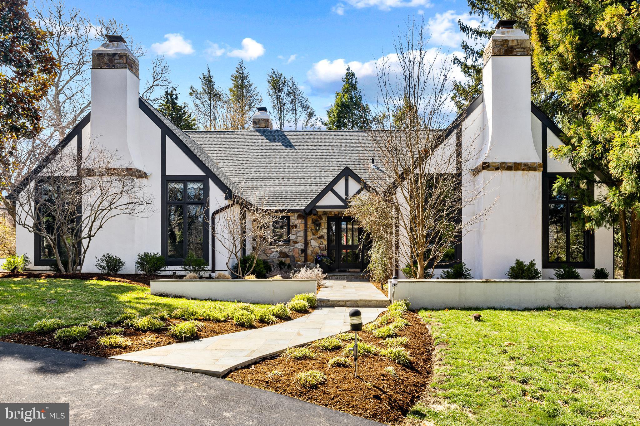 Approximately 4200 Sq Ft Nestled in Wynnewood’s most sought-after school district, this stunning English country estate blends timeless elegance with modern luxury. Designed by renowned architect Ann Capron and meticulously updated, this Tudor-style masterpiece sits on a private, lushly landscaped lot with a circular driveway and a completely redesigned heated pool.

Inside, exquisite craftsmanship shines with pegged hardwood floors, rich woodwork, and vaulted ceilings. The expanded family room features a dramatic stone fireplace, built-ins, and seamless indoor-outdoor flow. The all-new chef’s kitchen is a showstopper, boasting custom cabinetry, exquisite quartzite countertops, and top-of-the-line appliances.

The first-floor primary suite is a serene retreat with a fireplace and spa-like bath. Upstairs, additional bedrooms offer flexibility for guests or office space. Multiple off-leash hiking trails are just minutes away, making this home perfect for those who love both luxury and nature.

A rare opportunity to own a truly exceptional property in a premier location!