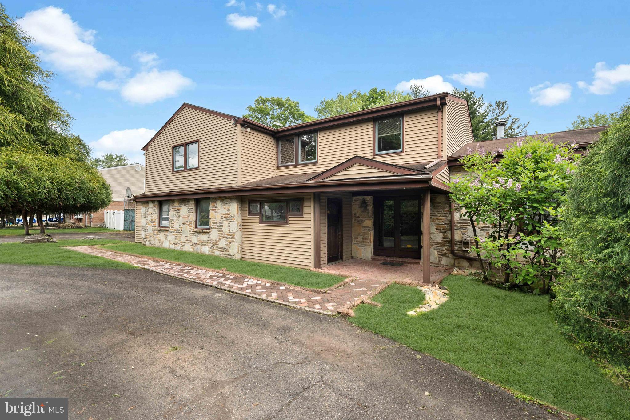 Situated on a generous half-acre lot in a prime location within the highly sought-after Lower Moreland School District, this expansive split-level residence offers exceptional space, versatility, and endless potential. A grand governor’s driveway leads to an oversized private parking area, while a separate side entrance provides the perfect opportunity for an in-home business, private office, or future in-law suite.

Step inside through the impressive foyer and immediately appreciate the home’s spacious layout. To the right, a formal living room filled with natural light from a large bay window seamlessly connects to the formal dining room, creating an ideal setting for entertaining. Adjacent to the dining room is the oversized kitchen featuring custom oak cabinetry throughout, a dedicated breakfast area, and a charming corner wine bar. The kitchen overlooks the expansive backyard and opens through oversized sliding glass doors to the outdoor living space.

Beyond the kitchen, the inviting family room showcases a striking floor-to-ceiling granite stone wall with a wood-burning fireplace and custom built-in shelving, creating a warm and welcoming atmosphere. Continuing further, the four-season sunroom offers walls of sliding glass doors that provide direct access to the backyard and private tennis court. A full bathroom and office spaces complete the first floor, offering incredible flexibility for today’s lifestyle needs.

Upstairs, you’ll find four generously sized bedrooms, each with ample closet space. The oversized primary suite features elegant double-door entry, his-and-her walk-in closets, potential access for a future private balcony, and a stunning custom-built en-suite bathroom. The luxurious primary bath includes an oversized Jacuzzi tub, an open walk-in glass block shower, and an expansive vanity with dual sinks and a dedicated makeup area. Two additional bathrooms, and three linen closets complete the second floor, including a hall bathroom remodeled in 2021.

The fully finished basement, completed in 2021, adds even more functional living and entertaining space. Outside, the expansive backyard offers endless possibilities, highlighted by a private tennis court ready for your personal touch and updates.

With incredible square footage, unique architectural features, and outstanding potential, this is a rare opportunity to create your dream home in one of the area’s most desirable neighborhoods.
