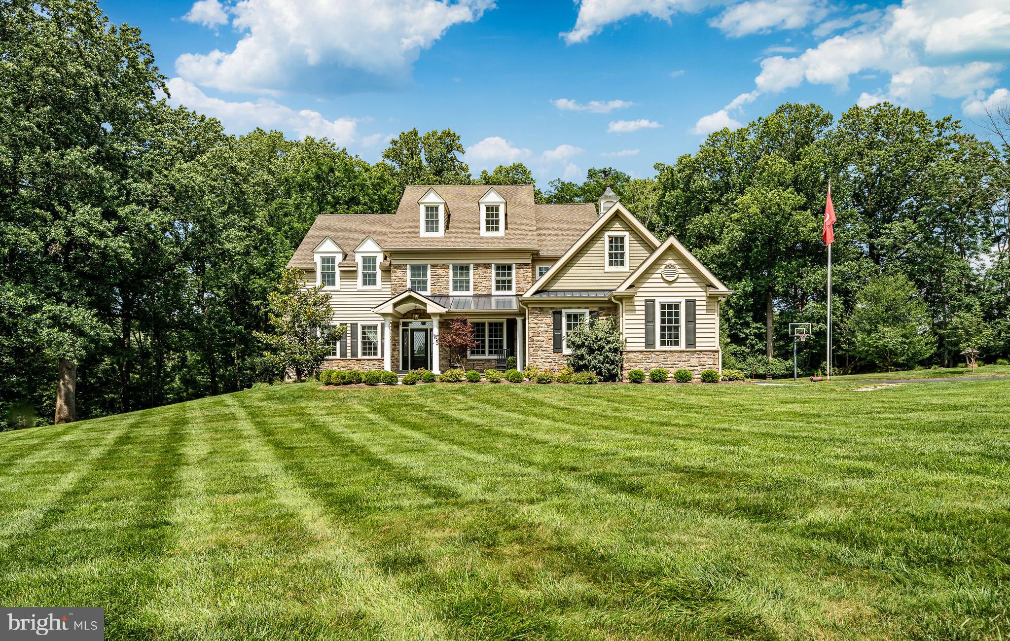 Luxury Living Meets Timeless Charm in  the coveted Radnor Hunt subdivision of Willistown Township! The endless opportunities begin at 211 Dutton Mill Road—an extraordinary, custom-built estate designed with sophistication, versatility, and multi-generational living in mind. Privately tucked away on a lush, level lot in the heart of the award-winning Great Valley School District, this luxurious property includes two distinct residences and a striking converted barn, offering endless potential for a wide range of lifestyles. Expertly designed by acclaimed architect McIntyre Capron and built by Mullray Builders, the main home exudes modern luxury across more than 6,800 square feet of expertly finished living space. From the moment you arrive, meticulous craftsmanship and high-end finishes are evident throughout. A flagstone path leads to an elegant entry flanked by formal spaces that feature transom windows, crown molding, and wainscoting. The heart of the home is the expansive chef's kitchen—complete with top-tier stainless appliances, a generous center island with seating for four and above pendant lighting, abundant cabinetry, and a warm breakfast room with slate-surround fireplace and custom shutters. The kitchen flows seamlessly into a dramatic family room showcasing vaulted ceilings, a floor-to-ceiling stone fireplace, and two-story windows that flood the space with natural light. French doors lead to the rear deck with greenery all around you.  The first-floor primary suite is a serene retreat with a fireplace in the main quarters and offering a private sitting room , dual walk-in closets, and a spa-like bathroom featuring a striking copper soaking tub, walk-in tile shower with custom stone niche, and separate vanities. Upstairs, you'll find four additional ensuite bedrooms, as well as thoughtfully designed spaces for work, play, and hobbies—including a built-in study area and a dedicated craft room.  Custom "hideouts" can be found for family fun or secret storage spaces. The finished walk-out lower level is perfect for entertaining, with a custom stone wet bar and ample space for media, fitness, or recreation.  Outside, the property is framed by manicured gardens, dramatic landscape lighting, and mature trees, creating a truly private oasis.  Make your way down the extended driveway & you will enter the secondary residence.  Perfectly suited for multi-generational living, completely updated second home offers true one-floor living with 3 bedrooms and 1.5 bathrooms. Whether used as in-law quarters, guest accommodations, or a private home office, this residence provides comfort and flexibility , all surrounded by mature landscaping and open yard space.  A standout feature of this property is the expansive converted barn, a multifunctional structure that’s ideal for entertaining, storing collectibles, or housing a car enthusiast’s dream garage. Whether you're hosting unforgettable gatherings or seeking additional storage, this space delivers both style and function. Nestled in one of Chester County’s most desirable school districts, this estate offers the rare combination of luxury, privacy, and convenience With quick access to major commuter routes and  just minutes from the vibrant towns of Malvern, West Chester, and the Main Line this is the home you've been dreaming of. .