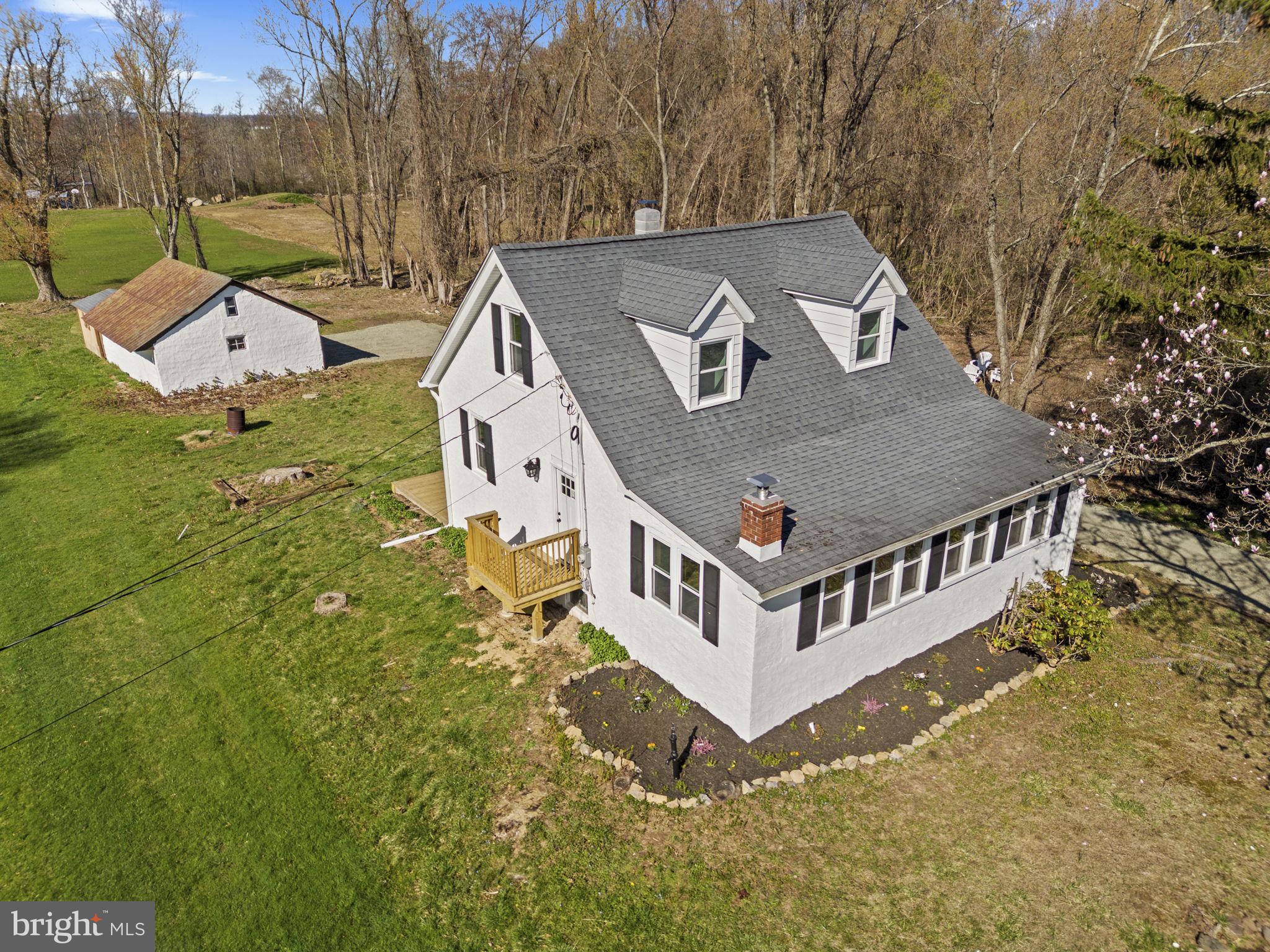***PRICE REDUCTION AND ADDITIONAL 5K SPENT IN IMPROVEMENTS*** 
Refreshed Country Cape Cod on 1.44 Serene Acres with 2-Car Garage and Privacy Fence!
This beautifully refreshed Cape Cod combines authentic historic character with contemporary updates, all set on a sprawling 1.44 acre lot with an oversized two-car garage. This country sanctuary offers a sophisticated yet cozy lifestyle where you can enjoy your private fenced-in yard from your brand-new deck before stepping inside to a home that feels entirely new.

The heart of the home is the modern kitchen, which serves as a showpiece with its sleek granite countertops, stainless steel appliances, new cabinetry, and updated fixtures. This space flows effortlessly into the formal dining area, an inviting setting for gatherings of any size. The living and sitting areas preserve the home's original soul, highlighted by exposed beams, wood accent walls, and a wood-burning stove set against a stunning stone wall. Continuing on the main level, the primary suite has been thoughtfully expanded to accommodate a full suite of furniture. Just steps away, the full bathroom has been completely reimagined with a newly tiled shower and tub combination, a fresh vanity, and a new toilet—all supported by updated PVC and Pex plumbing.

Upstairs, two sizable bedrooms featuring dormer bump-outs provide extra square footage, finished with fresh paint and brand-new carpeting. Spend early mornings enjoying a coffee outside on the extensive deck. For the hobbyist, the property features a detached shed specifically outfitted as a workshop space, now featuring new dedicated electric to support everything from weekend DIY to professional-grade projects.

Beyond the aesthetic updates, this home offers peace of mind with significant mechanical upgrades. The electrical service has been updated to 200 amps for the main house, with new electric also extended to the garage and shed. Recessed lighting has been installed throughout to enhance the bright, airy feel, complemented by thermal windows,  new flooring, and fresh paint from top to bottom. Additional recent upgrades include a new sump pump, water conditioning system, and privacy fencing. 

The location offers the best of both worlds - peaceful, rural living that remains perfectly connected. Enjoy a simplified commute with a quick drive to the PA Turnpike, or spend your weekends at nearby Green Lane Park, a local landmark for community events, hiking, and boating.

Schedule your private tour today to experience this beautiful country escape for yourself!
