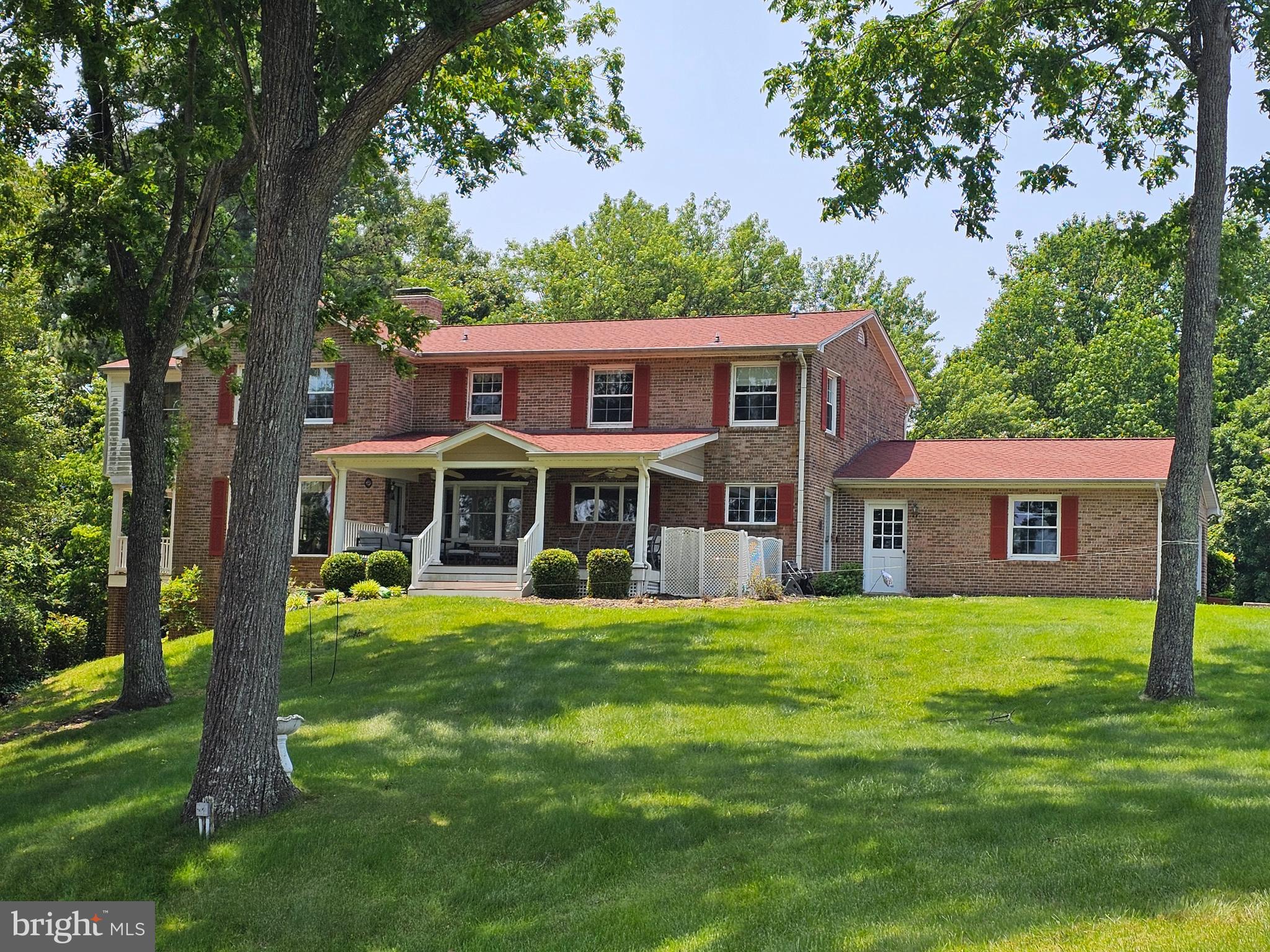 Exceptional waterfront living awaits at 23500 River Road in Town Creek, Maryland. Situated on 1.32 beautifully maintained acres along the Patuxent River, this expansive 3,952 sq. ft. home offers a rare combination of warmth, comfort, functionality, and breathtaking waterfront lifestyle.

Designed for both everyday living and entertaining, this 17-room home features four spacious upper-level bedrooms, three full baths upstairs, two half baths on the main level, and an additional full bath and bedroom on the lower level. Multiple rooms throughout the home showcase sweeping water views of the Patuxent River and Thomas Johnson Bridge.

The oversized primary suite serves as a private retreat, complete with soaring ceilings, dual closets including a large walk-in closet, and a beautifully updated en suite bath featuring heated floors, dual vanities, a newly tiled walk-in shower, private water closet, and an in-suite washer and dryer for added convenience.

The heart of the home is the custom kitchen featuring Amish-crafted cabinetry, custom organizational pantry shelving, granite countertops, center island cooktop, double ovens, under-counter microwave, custom built-in desk, and double sink perfectly positioned to overlook the waterfront and backyard.

Warmth and character flow throughout the home with hardwood flooring, herringbone hardwood foyer accents, parquet hallway flooring upstairs, fresh carpeting, 18-inch travertine tile, and three gas fireplaces located in the living room, family room, and lower-level entertaining area.

Outdoor living is equally impressive with two Trex decks, including a covered waterfront-facing deck ideal for relaxing, entertaining, or enjoying stunning sunrises over the river and sunsets behind the TJ Bridge. The private six-foot-wide pier features newly completed 2026 decking, boat lift access(as-is), and quick navigable access to the Chesapeake Bay for boating, fishing, crabbing, kayaking, and waterfront adventures.

Additional features include:

Whole-house central vacuum system
Two programmable HVAC systems
Six fully owned solar panels
Extensive storage throughout every level
22x26 attached garage with separate storage/workshop room
Lower-level second kitchen/wet bar
Mudroom with full laundry area, in addition to upper-level laundry, in the primary bathroom.

Enjoy front-row views of local waterfront events, Blue Angels flyovers, PyroJam performances, and spectacular sun rises AND sunsets, while still maintaining convenient access to shopping, dining, local marinas, NAS Patuxent River, and commuter routes.

This is more than a home — it is a waterfront legacy property thoughtfully maintained and designed to be enjoyed for generations.