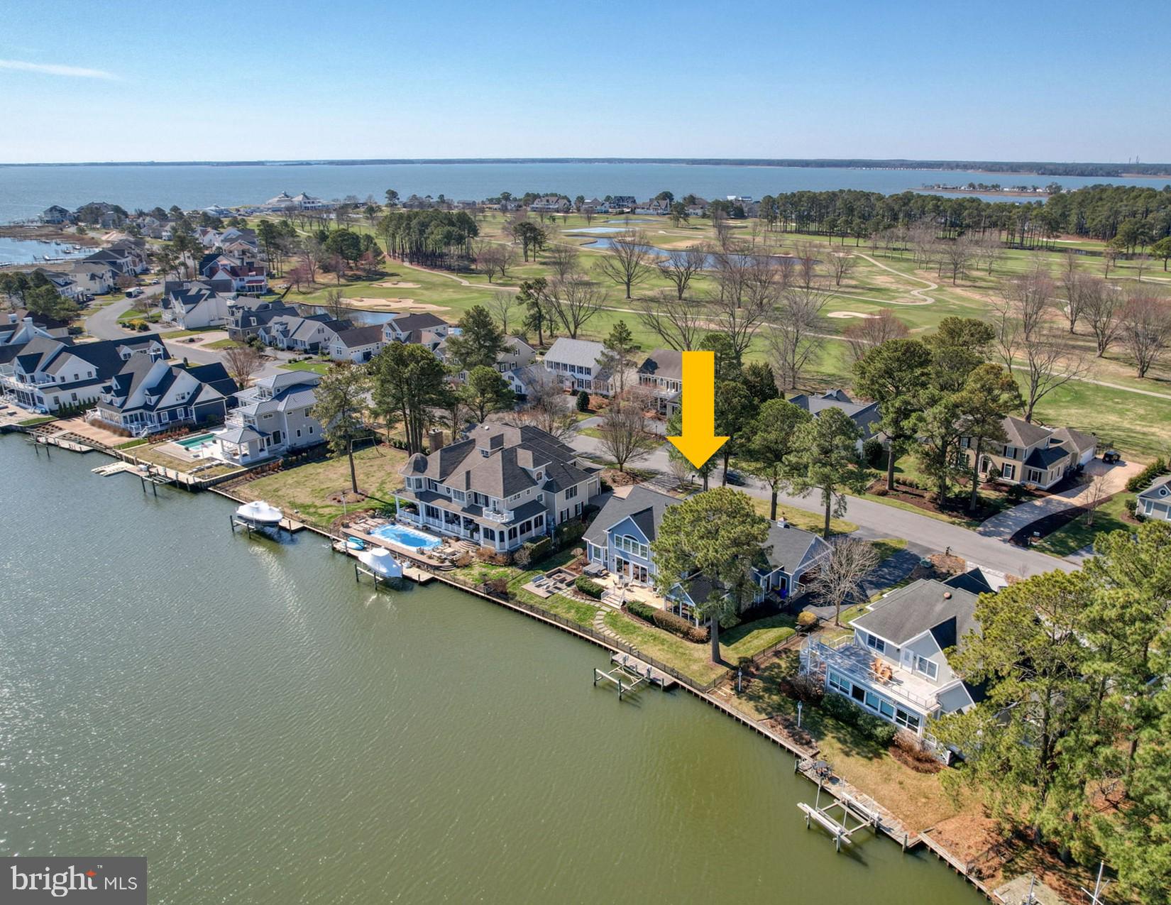 Welcome to 119 East Side Drive—a spectacular coastal waterfront retreat set on a generous .36-acre bulkheaded lot, complete with private boat lift and direct access to the Rehoboth Bay. Offering approximately 3,950 square feet of heated living space and over 6,000 total square feet, this home seamlessly blends refined interiors with relaxed coastal living.  A grand two-story foyer welcomes you inside, where natural light pours into the elegant dining room, highlighted by a bay window with views of the golf course. The adjacent great room impresses with coffered ceilings, a gas fireplace, and expansive sliders that open to a stunning teak deck—perfect for entertaining or simply taking in panoramic canal and bay views.  The well-appointed kitchen features stainless steel appliances, granite countertops, and a charming breakfast nook nestled within a sunlit bay window. Just beyond, you’ll find a thoughtfully designed service area that includes a wet bar, powder room, Butler’s pantry with custom built-ins, additional pantry closet, and a spacious laundry/mudroom connecting to the oversized garage.
Designed for comfort and gathering, the family room boasts a cathedral ceiling with inlaid wood detail and a dramatic floor-to-ceiling stone, wood-burning fireplace. From here, step into the three-season room with its own cathedral ceiling—an inviting space that transitions effortlessly into a screened porch during warmer months. The three-season room opens to a private backyard oasis featuring a teak deck, hot tub, paver patio with firepit, and outdoor shower—ideal after a day on the boat or at the beach.
Boating enthusiasts will appreciate the private lift (accommodating up to a 6,000-pound boat), ample docking space for additional watercraft, and easy canal access to Rehoboth Bay.
The first-floor owner’s suite offers a peaceful retreat with double-door entry, crown molding, plantation shutters, dual closets, and a spacious ensuite bath complete with double vanities, makeup area, separate water closet, and tiled shower.
Upstairs, four additional bedrooms and two full baths provide plenty of space for family and guests. One bedroom features a private ensuite, while a large waterfront room—currently used as an office or secondary living space—is already plumbed for an additional ensuite bath, offering flexibility for future customization.   
Ideally located near the beach, boardwalk, dining, and all that Rehoboth has to offer, this home also enjoys close proximity to the Rehoboth Beach Country Club, with optional membership for golf, tennis, pickleball, and more.
Experience the ultimate waterfront lifestyle in this serene coastal escape—where your daily choice might just be whether to walk, bike, drive, or boat to your lunch or dinner destination. Don’t miss the opportunity to view the video tour and see it all for yourself.