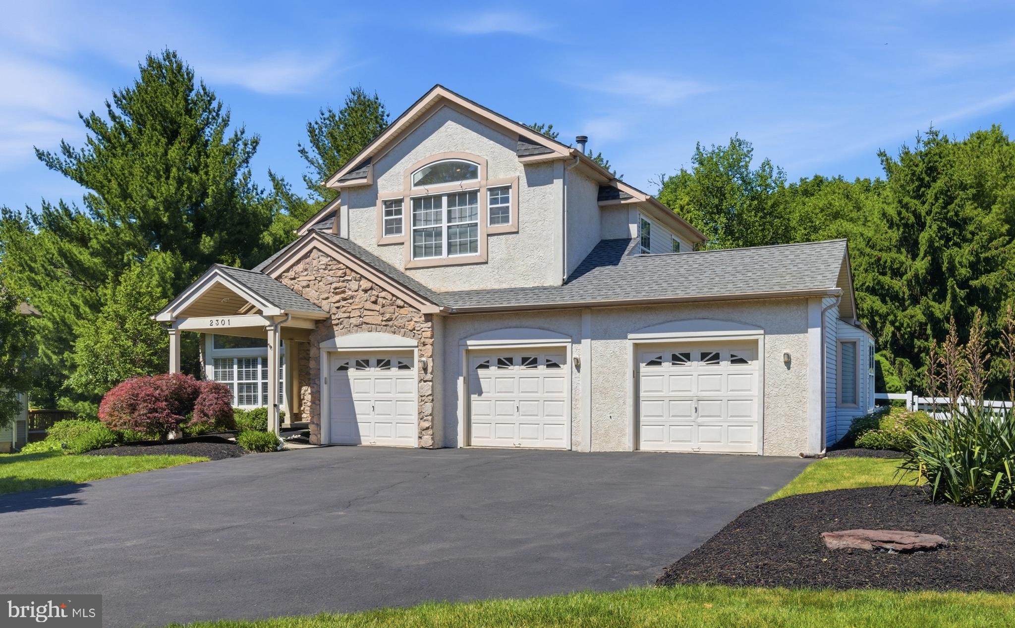 Welcome to this stunning former model home in the highly sought-after Forest Glen community of Warrington Township — where modern elegance meets everyday comfort. Boasting over 3,100 square feet of beautifully designed living space, this contemporary showpiece offers an open-concept layout, soaring ceilings, and upscale finishes throughout. Step onto the stylish covered front porch and into a dramatic two-story foyer that immediately makes a lasting impression. Gorgeous hardwood floors flow seamlessly through the foyer, family room, and kitchen, while oversized windows flood the home with natural light. At the heart of the home is the spectacular family room, featuring a striking gas fireplace with a custom stone and shiplap surround, elegant mantle, and built-in shelving — the perfect gathering space for relaxing or entertaining. The adjacent gourmet kitchen is equally impressive with a large center island, granite countertops, subway tile backsplash, stainless steel appliances, and easy access to the backyard deck through oversized atrium doors. The open dining area includes a custom built-in butler’s cabinet and flows effortlessly into the formal living room, creating an ideal setting for both intimate dinners and larger gatherings. A convenient laundry room and powder room complete the main level. Upstairs, the luxurious primary suite is a true retreat, highlighted by a coffered ceiling, generous closet space, and a spa-inspired ensuite bath featuring a soaking tub, oversized walk-in shower, and dual vanities. Two additional spacious bedrooms and a full hall bath complete the upper level. The finished lower level offers incredible versatility with nearly an entire additional floor of living space — perfect for a media room, home gym, office, guest suite, or future fourth bedroom — plus abundant storage. Additional highlights include a rare three-car garage, public water and sewer, central air, and a prime location within the award-winning Central Bucks School District. This exceptional home combines luxury, functionality, and timeless style — all in one incredible package.